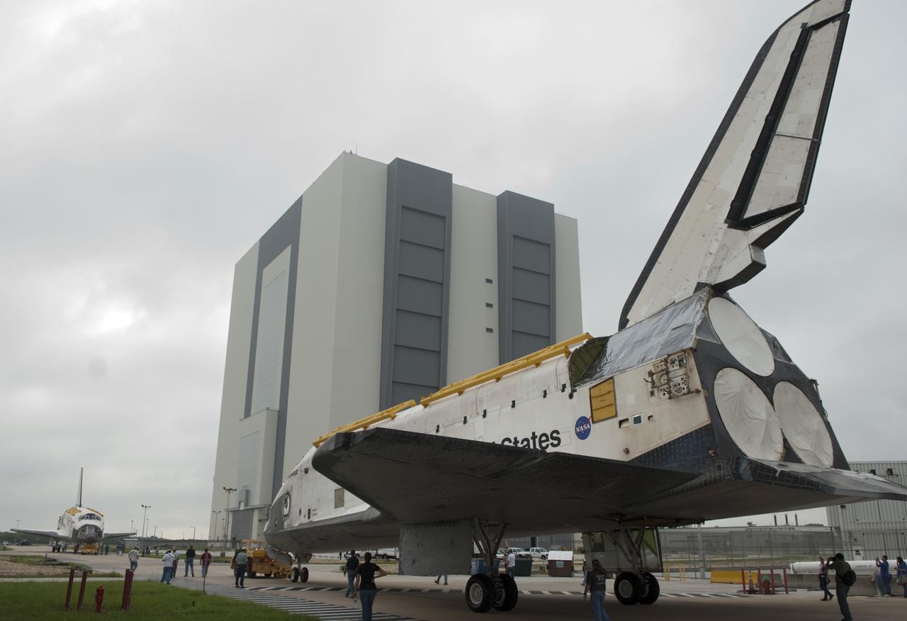CAPE CANAVERAL, Fla. -- At NASA's Kennedy Space Center in Florida, space shuttles Discovery, at right, and Endeavour pause outside Orbiter Processing Facility-3 (OPF-3) for a unique "nose-to-nose" photo opportunity.  Discovery, which temporarily was being stored in the Vehicle Assembly Building (VAB), is switching places with Endeavour, which has been undergoing decommissioning in OPF-1.  Discovery then will be rolled into OPF-1 and Endeavour into the VAB.    In OPF-1, Discovery will undergo further preparations for public display at the Smithsonian's National Air and Space Museum Steven F. Udvar-Hazy Center in Virginia. Endeavour will be stored in the VAB until October when it will be moved into OPF-2 for further work to get it ready for public display at the California Science Center in Los Angeles.  For more information, visit http://www.nasa.gov/shuttle. Photo credit: NASA/Jim Grossmann