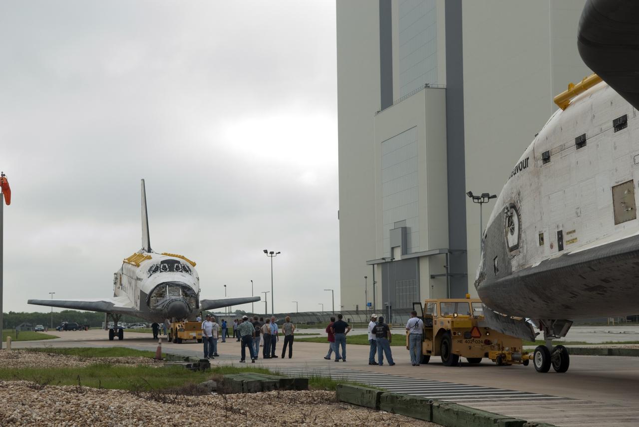 CAPE CANAVERAL, Fla. -- At NASA's Kennedy Space Center in Florida, space shuttles Discovery, at left, and Endeavour stop outside Orbiter Processing Facility-3 (OPF-3) for a unique "nose-to-nose" photo opportunity.  Discovery, which temporarily was being stored in the Vehicle Assembly Building (VAB), is switching places with Endeavour, which has been undergoing decommissioning in OPF-1.  Discovery then will be rolled into OPF-1 and Endeavour into the VAB.    In OPF-1, Discovery will undergo further preparations for public display at the Smithsonian's National Air and Space Museum Steven F. Udvar-Hazy Center in Virginia. Endeavour will be stored in the VAB until October when it will be moved into OPF-2 for further work to get it ready for public display at the California Science Center in Los Angeles.  For more information, visit http://www.nasa.gov/shuttle. Photo credit: NASA/Jim Grossmann