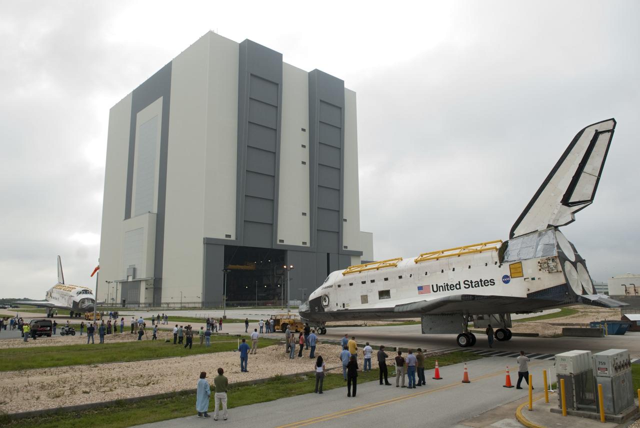 CAPE CANAVERAL, Fla. -- At NASA's Kennedy Space Center in Florida, employees and media representatives set up their cameras to capture space shuttles Discovery, at left, and Endeavour outside Orbiter Processing Facility-3 (OPF-3) during a unique "nose-to-nose" photo opportunity.  Discovery, which temporarily was being stored in the Vehicle Assembly Building (VAB), is switching places with Endeavour, which has been undergoing decommissioning in OPF-1.  Discovery then will be rolled into OPF-1 and Endeavour into the VAB.    In OPF-1, Discovery will undergo further preparations for public display at the Smithsonian's National Air and Space Museum Steven F. Udvar-Hazy Center in Virginia. Endeavour will be stored in the VAB until October when it will be moved into OPF-2 for further work to get it ready for public display at the California Science Center in Los Angeles.  For more information, visit http://www.nasa.gov/shuttle. Photo credit: NASA/Jim Grossmann