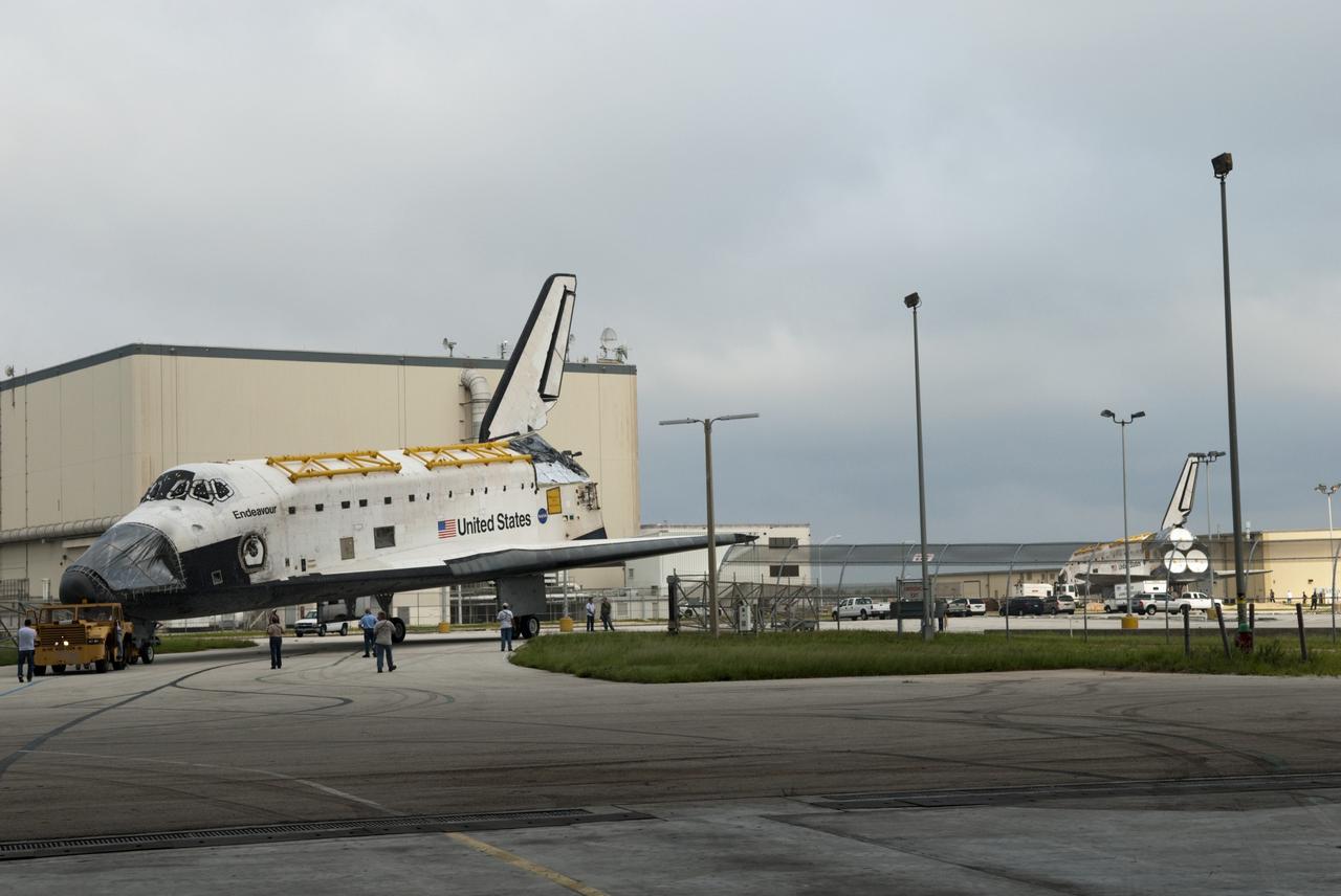 CAPE CANAVERAL, Fla. -- At NASA's Kennedy Space Center in Florida, space shuttle Endeavour continues on its way to the Vehicle Assembly Building (VAB), where it temporarily will be stored.  Endeavour is swapping places with Discovery, at right, on its way to Orbiter Processing Facility-1 (OPF-1) where its decommissioning activities will resume.  The shuttles stopped briefly outside OPF-3 for a unique "nose-to-nose" photo opportunity.    In OPF-1, Discovery will undergo further preparations for public display at the Smithsonian's National Air and Space Museum Steven F. Udvar-Hazy Center in Virginia. Endeavour will be stored in the VAB until October when it will be moved into OPF-2 for further work to get it ready for public display at the California Science Center in Los Angeles.  For more information, visit http://www.nasa.gov/shuttle. Photo credit: NASA/Jim Grossmann