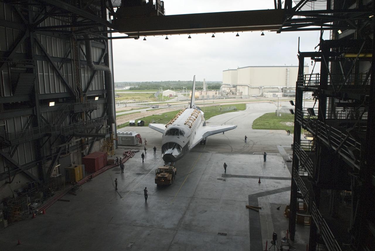 CAPE CANAVERAL, Fla. -- At NASA's Kennedy Space Center in Florida, space shuttle Endeavour enters the open bay of the Vehicle Assembly Building (VAB), where it temporarily will be stored.  Endeavour is swapping places with Discovery, which will resume decommissioning activities in Orbiter Processing Facility-1 (OPF-1), in the background.  The shuttles stopped briefly outside OPF-3 for a unique "nose-to-nose" photo opportunity.    In OPF-1, Discovery will undergo further preparations for public display at the Smithsonian's National Air and Space Museum Steven F. Udvar-Hazy Center in Virginia. Endeavour will be stored in the VAB until October when it will be moved into OPF-2 for further work to get it ready for public display at the California Science Center in Los Angeles.  For more information, visit http://www.nasa.gov/shuttle. Photo credit: NASA/Jim Grossmann