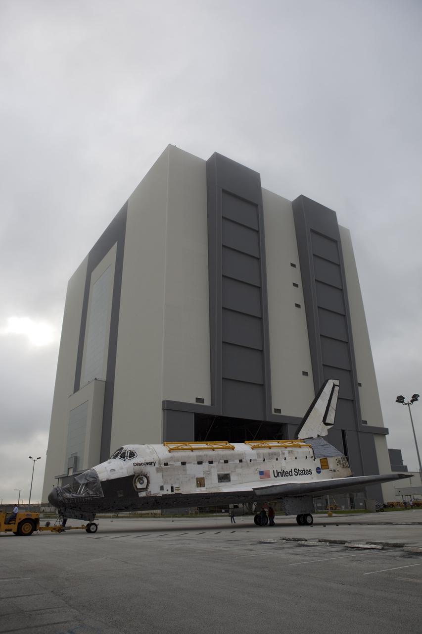 CAPE CANAVERAL, Fla. -- At NASA's Kennedy Space Center in Florida, space shuttle Discovery is towed from the 525-foot-tall Vehicle Assembly Building (VAB), beginning its move to Orbiter Processing Facility-1 (OPF-1).  Discovery is switching places with shuttle Endeavour which has been undergoing decommissioning activities in OPF-1.  Both shuttles will stop briefly outside OPF-3 for a "nose-to-nose" photo opportunity. Discovery then will be rolled into OPF-1 and Endeavour into the VAB.    In OPF-1, Discovery will undergo further preparations for public display at the Smithsonian's National Air and Space Museum Steven F. Udvar-Hazy Center in Virginia. Endeavour will be stored in the VAB until October when it will be moved into OPF-2 for further work to get it ready for public display at the California Science Center in Los Angeles.  For more information, visit http://www.nasa.gov/shuttle. Photo credit: NASA/Dimitri Gerondidakis