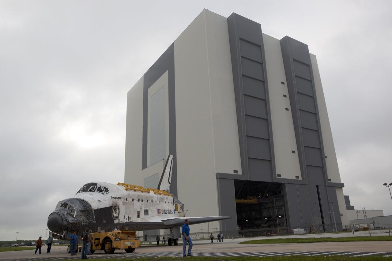 CAPE CANAVERAL, Fla. -- At NASA's Kennedy Space Center in Florida, space shuttle Discovery rounds a curve as it is towed from the 525-foot-tall Vehicle Assembly Building (VAB) to Orbiter Processing Facility-1 (OPF-1).  Discovery is switching places with shuttle Endeavour which has been undergoing decommissioning activities in OPF-1.  Both shuttles will stop briefly outside OPF-3 for a "nose-to-nose" photo opportunity. Discovery then will be rolled into OPF-1 and Endeavour into the VAB.    In OPF-1, Discovery will undergo further preparations for public display at the Smithsonian's National Air and Space Museum Steven F. Udvar-Hazy Center in Virginia. Endeavour will be stored in the VAB until October when it will be moved into OPF-2 for further work to get it ready for public display at the California Science Center in Los Angeles.  For more information, visit http://www.nasa.gov/shuttle. Photo credit: NASA/Dimitri Gerondidakis