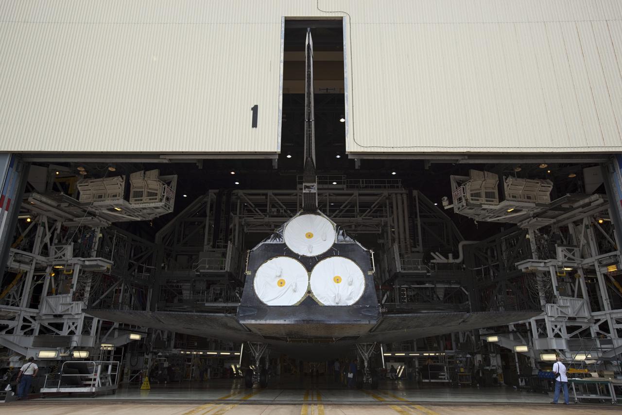 CAPE CANAVERAL, Fla. -- At NASA's Kennedy Space Center in Florida, space shuttle Discovery arrives inside  Orbiter Processing Facility-1 (OPF-1) after participating in a unique "nose-to-nose" photo opportunity outside OPF-3 with shuttle Endeavour. Discovery is switching places with Endeavour which temporarily is being placed in storage in the Vehicle Assembly Building (VAB).    In OPF-1, Discovery will undergo further preparations for public display at the Smithsonian's National Air and Space Museum Steven F. Udvar-Hazy Center in Virginia. Endeavour will be stored in the VAB until October when it will be moved into OPF-2 for further work to get it ready for public display at the California Science Center in Los Angeles.  For more information, visit http://www.nasa.gov/shuttle. Photo credit: NASA/Dimitri Gerondidakis