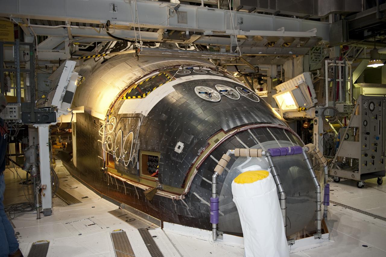 CAPE CANAVERAL, Fla. -- In Orbiter Processing Facility-2 (OPF-2) at NASA’s Kennedy Space Center in Florida, work begins to remove space shuttle Atlantis’ forward reaction control system. The system provided maneuvering capabilities to the spacecraft during its missions. Atlantis glided to a landing, July 21, 2011, at Kennedy Space Center’s Shuttle Landing Facility, completing NASA’s final space shuttle mission, STS-135. The shuttle is in OPF-2 being decommissioned and prepared for eventual display at the Kennedy Space Center Visitor Complex in Florida. Photo credit: Kim Shiflett