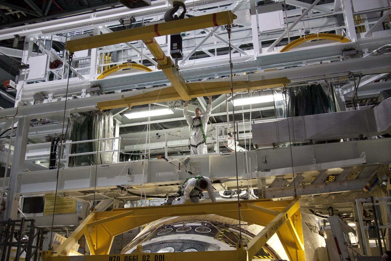 CAPE CANAVERAL, Fla. -- In Orbiter Processing Facility-2 (OPF-2) at NASA’s Kennedy Space Center in Florida, technicians help guide a special crane around space shuttle Atlantis so that work can begin to remove its forward reaction control system. The system provided maneuvering capabilities to the spacecraft during its missions. Atlantis glided to a landing, July 21, 2011, at Kennedy Space Center’s Shuttle Landing Facility, completing NASA’s final space shuttle mission, STS-135. The shuttle is in OPF-2 being decommissioned and prepared for eventual display at the Kennedy Space Center Visitor Complex in Florida. Photo credit: Jim Grossmann