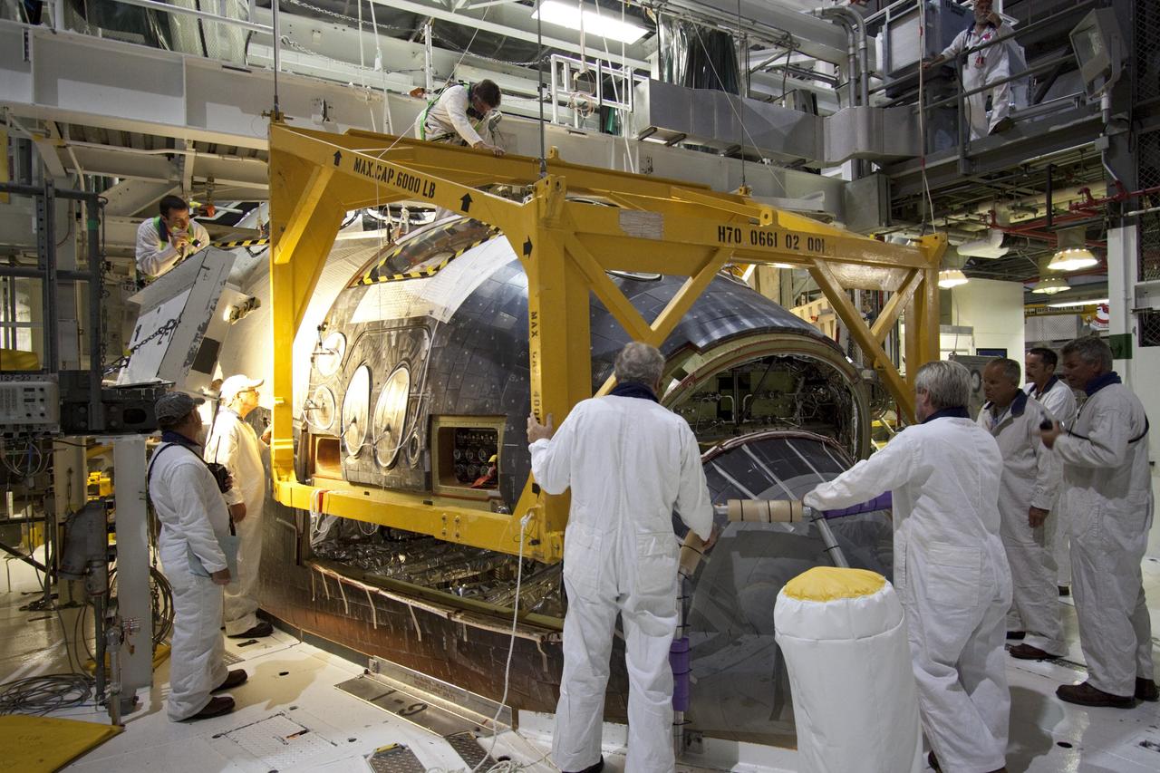 CAPE CANAVERAL, Fla. -- In Orbiter Processing Facility-2 (OPF-2) at NASA’s Kennedy Space Center in Florida, technicians help secure a special crane around space shuttle Atlantis as work begins to remove the spacecraft’s forward reaction control system. The system provided some of the maneuvering capabilities to the spacecraft during its missions. Atlantis glided to a landing, July 21, 2011, at Kennedy Space Center’s Shuttle Landing Facility, completing NASA’s final space shuttle mission, STS-135. The shuttle is in OPF-2 being decommissioned and prepared for eventual display at the Kennedy Space Center Visitor Complex in Florida. Photo credit: Jim Grossmann