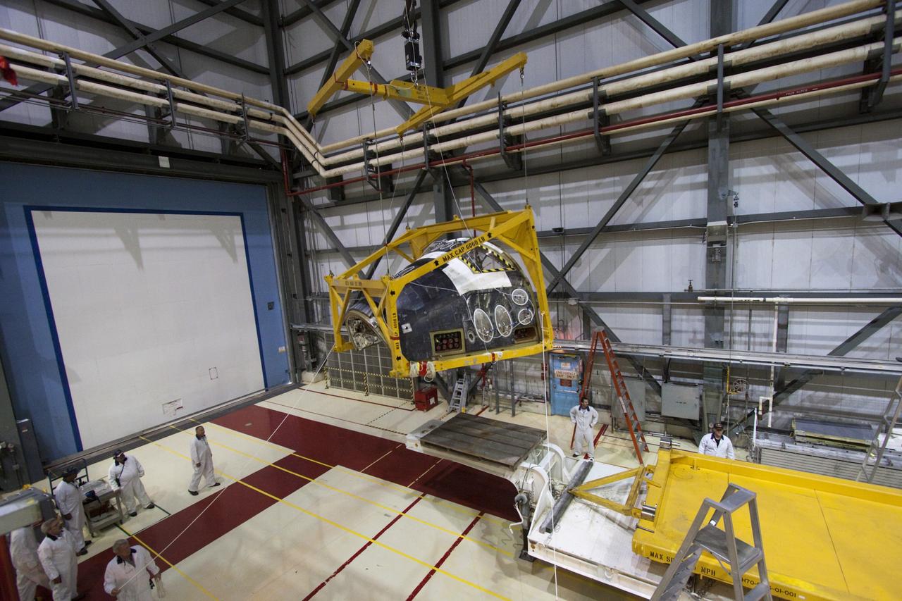 CAPE CANAVERAL, Fla. -- In Orbiter Processing Facility-2 (OPF-2) at NASA’s Kennedy Space Center in Florida, technicians monitor the progress of a special crane as it lowers space shuttle Atlantis’ forward reaction control system onto a transporter. The system, which provided maneuvering capabilities to the shuttle during its missions, will be transported to White Sands Space Harbor in New Mexico to undergo a complete deservicing and cleaning. Atlantis glided to a landing, July 21, 2011, at Kennedy Space Center’s Shuttle Landing Facility, completing NASA’s final space shuttle mission, STS-135. The shuttle is in OPF-2 being decommissioned and prepared for eventual display at the Kennedy Space Center Visitor Complex in Florida. Photo credit: Jim Grossmann