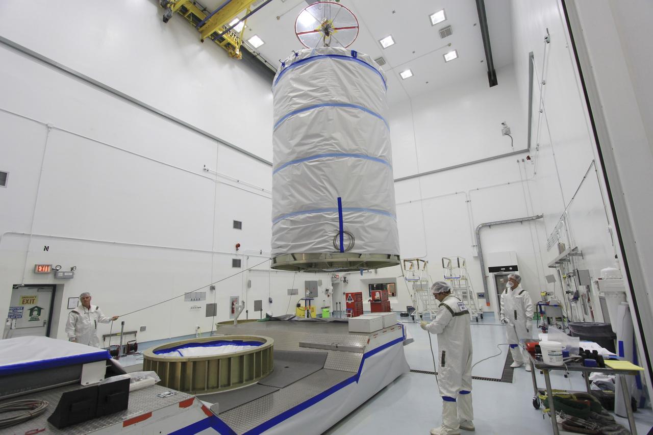CAPE CANAVERAL, Fla. -- At Astrotech Space Operation's payload processing facility in Titusville, Fla., a protective canister enclosing NASA's twin Gravity Recovery and Interior Laboratory spacecraft is lifted toward a transportation pallet. Preparations are under way to move the lunar probes, attached to a spacecraft adapter ring in their side-by-side launch configuration, to the launch pad.    The spacecraft will fly in tandem orbits around the moon for several months to measure its gravity field. GRAIL's primary science objectives are to determine the structure of the lunar interior, from crust to core, and to advance understanding of the thermal evolution of the moon.  Launch aboard a United Launch Alliance Delta II rocket from Space Launch Complex 17B on Cape Canaveral Air Force Station is scheduled for Sept. 8.  For more information, visit http://www.nasa.gov/grail. Photo credit: NASA/Jim Grossmann