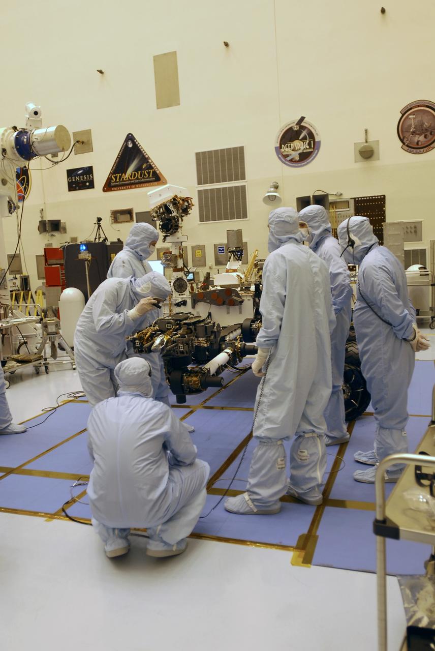 CAPE CANAVERAL, Fla. -- In the Payload Hazardous Servicing Facility at NASA's Kennedy Space Center in Florida, spacecraft technicians examine the Mars Science Laboratory (MSL) rover, Curiosity, to ensure that the proper steps have been taken to stow the spacecraft's robotic arm.    The arm will hold and maneuver instruments that will help scientists analyze Martian rocks and soil. Much like a human arm, the robotic arm has flexibility through shoulder, elbow, and wrist joints that permit the arm to extend, bend, and angle precisely against rocks and soil to grind away layers, take microscopic images and analyze their elemental composition.  At the end of the arm is a hand-like structure, the turret, for holding various tools that can spin through a 350-degree turning range.      A United Launch Alliance Atlas V-541 configuration will be used to loft MSL into space. Curiosity’s 10 science instruments are designed to search for evidence on whether Mars has had environments favorable to microbial life, including chemical ingredients for life.  The unique rover will use a laser to look inside rocks and release its gasses so that the rover’s spectrometer can analyze and send the data back to Earth. MSL is scheduled to launch Nov. 25 from Space Launch Complex 41 on Cape Canaveral Air Force Station in Florida. For more information, visit http://www.nasa.gov/msl. Photo credit: NASA/Charisse Nahser