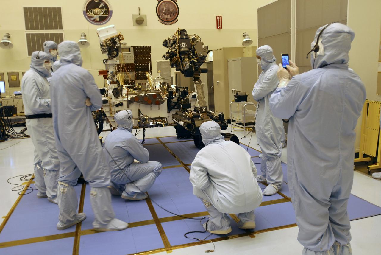 CAPE CANAVERAL, Fla. -- Under the watchful eyes of the spacecraft technicians in the Payload Hazardous Servicing Facility at NASA's Kennedy Space Center in Florida, the robotic arm of the Mars Science Laboratory (MSL) rover, Curiosity, moves into place against the body of the spacecraft. The arm will hold and maneuver instruments that will help scientists analyze Martian rocks and soil. Much like a human arm, the robotic arm has flexibility through shoulder, elbow, and wrist joints that permit the arm to extend, bend, and angle precisely against rocks and soil to grind away layers, take microscopic images and analyze their elemental composition. At the end of the arm is a hand-like structure, the turret, for holding various tools that can spin through a 350-degree turning range. A United Launch Alliance Atlas V-541 configuration will be used to loft MSL into space. Curiosity’s 10 science instruments are designed to search for evidence on whether Mars has had environments favorable to microbial life, including chemical ingredients for life. The unique rover will use a laser to look inside rocks and release its gasses so that the rover’s spectrometer can analyze and send the data back to Earth. MSL is scheduled to launch Nov. 25 from Space Launch Complex 41 on Cape Canaveral Air Force Station in Florida. For more information, visit http://www.nasa.gov/msl. Photo credit: NASA/Charisse Nahser