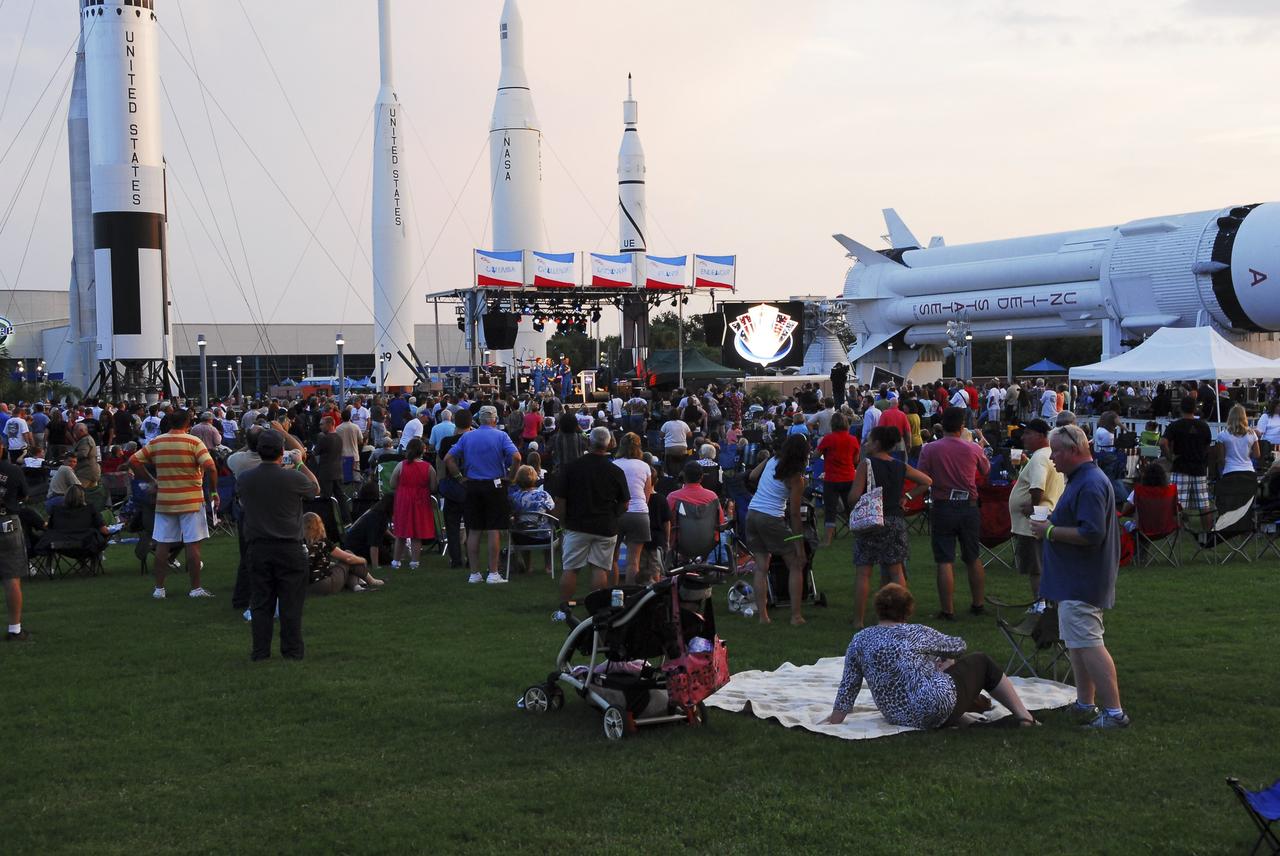 CAPE CANAVERAL, Fla. -- Thousands of space shuttle workers and their families gather near the Rocket Garden at the Kennedy Space Center Visitor Complex in Florida for the “We Made History! Shuttle Program Celebration” on Aug. 13. The event was held to honor current and former workers’ dedication to NASA’s Space Shuttle Program and to celebrate 30 years of space shuttle achievements. The event featured food, music, entertainment, astronaut appearances, educational activities, giveaways, and Starfire Night Skyshow. Photo credit: Jim Grossmann