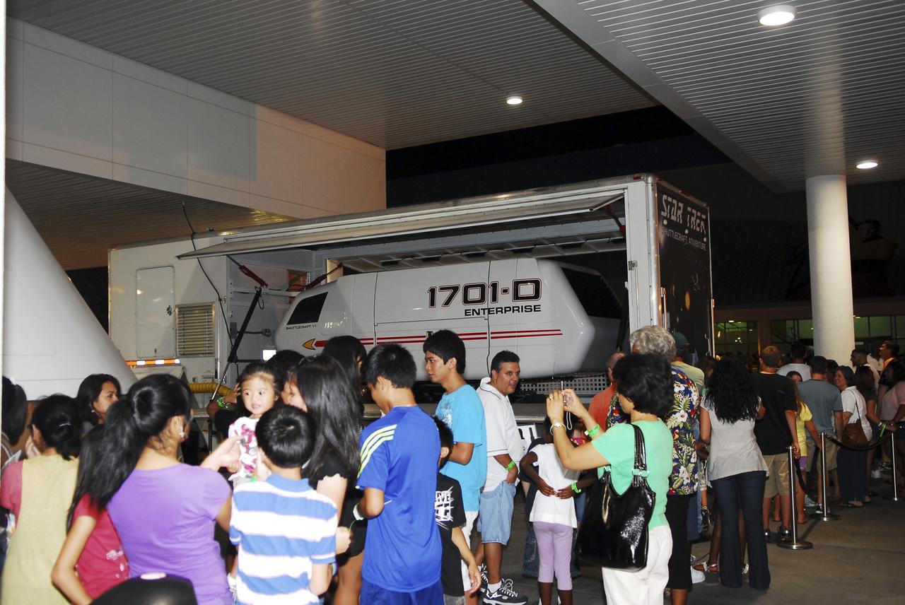 CAPE CANAVERAL, Fla. -- Thousands of space shuttle workers and their families gather near the "Star Trek" exhibit at the Kennedy Space Center Visitor Complex in Florida for the “We Made History! Shuttle Program Celebration” on Aug. 13. The event was held to honor current and former workers’ dedication to NASA’s Space Shuttle Program and to celebrate 30 years of space shuttle achievements. The event featured food, music, entertainment, astronaut appearances, educational activities, giveaways, and Starfire Night Skyshow. Photo credit: Jim Grossmann