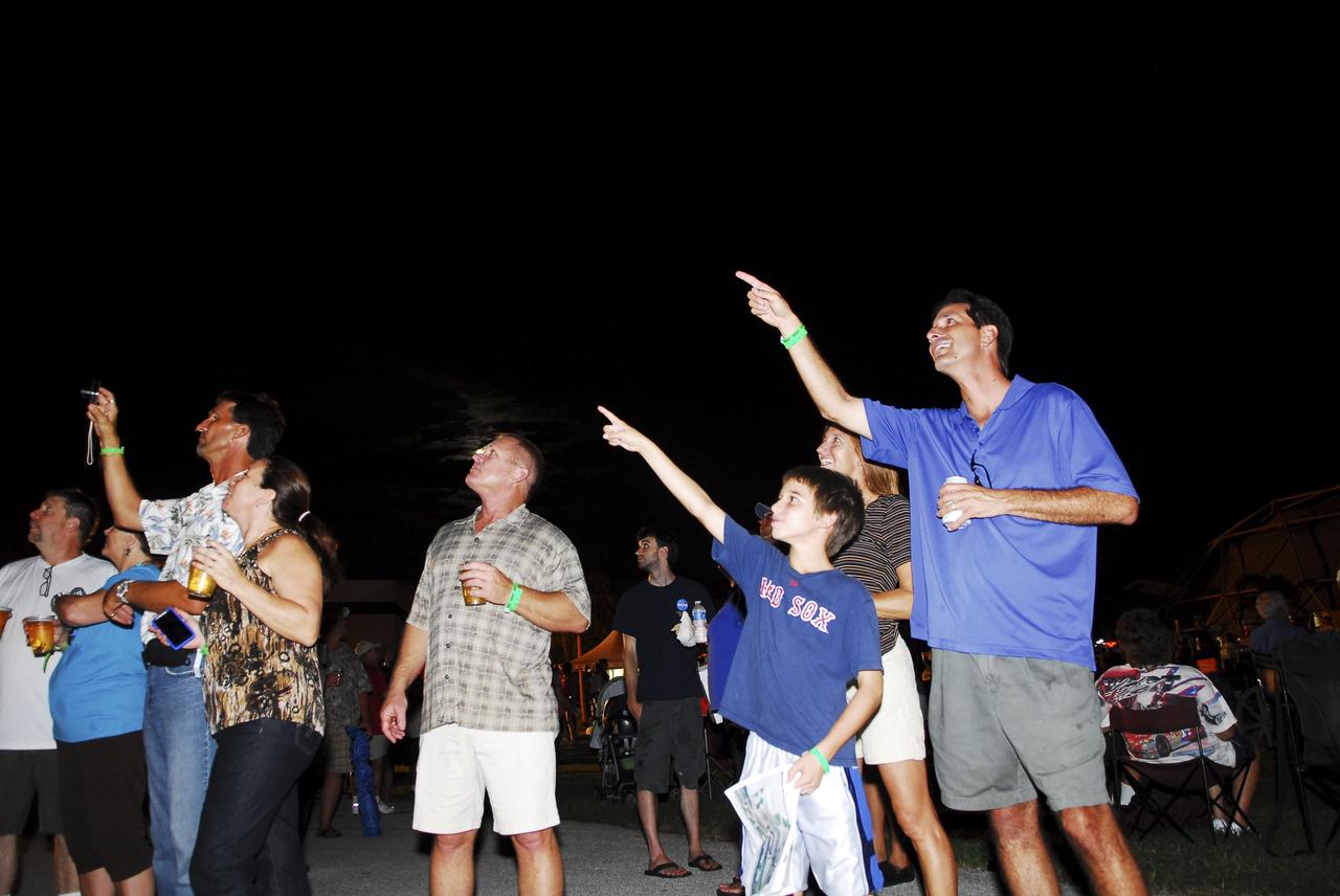 CAPE CANAVERAL, Fla. -- Thousands of space shuttle workers and their families watch a Starfire Night Skyshow at the “We Made History! Shuttle Program Celebration,” Aug. 13, at the Kennedy Space Center Visitor Complex, Fla. The event was held to honor shuttle workers’ dedication to NASA’s Space Shuttle Program and to celebrate 30 years of space shuttle achievements. The show featured spectacular night aerobatics with special computer-controlled lighting and firework effects on a plane flown by experienced pilot Bill Leff. The event also featured food, music, entertainment, astronaut appearances, educational activities and giveaways. Photo credit: Jim Grossmann