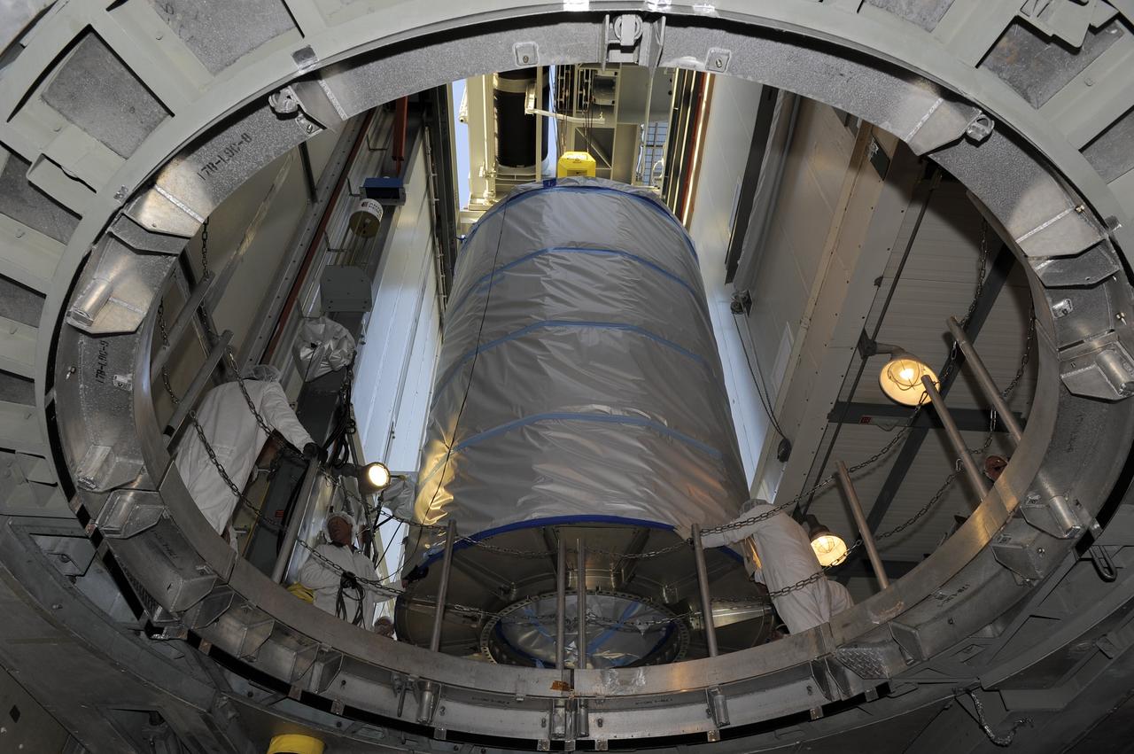 CAPE CANAVERAL, Fla. -- Technicians lower NASA's twin Gravity Recovery and Interior Laboratory (GRAIL) spacecraft into place atop a United Launch Alliance Delta II rocket on Space Launch Complex 17B at Cape Canaveral Air Force Station in Florida. The lunar probes are attached to a spacecraft adapter ring in their side-by-side launch configuration and wrapped in plastic to prevent contamination outside the clean room.      The spacecraft will fly in tandem orbits around the moon for several months to measure its gravity field. GRAIL's primary science objectives are to determine the structure of the lunar interior, from crust to core, and to advance understanding of the thermal evolution of the moon.  Launch is scheduled for Sept. 8. For more information, visit www.nasa.gov/grail. Photo credit: NASA/Kim Shiflett