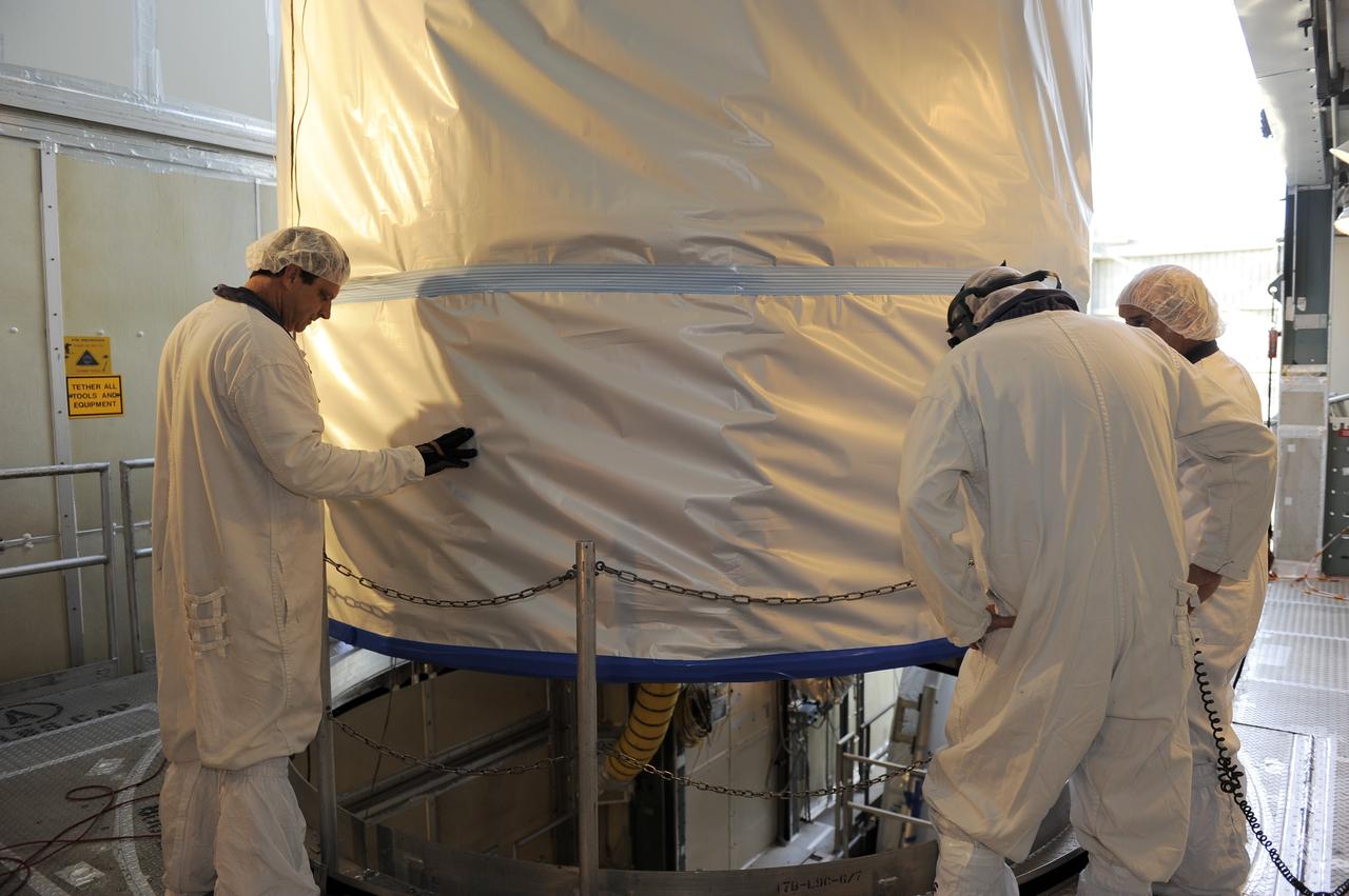 CAPE CANAVERAL, Fla. -- Technicians lower NASA's twin Gravity Recovery and Interior Laboratory (GRAIL) spacecraft into place atop a United Launch Alliance Delta II rocket on Space Launch Complex 17B at Cape Canaveral Air Force Station in Florida. The lunar probes are attached to a spacecraft adapter ring in their side-by-side launch configuration and wrapped in plastic to prevent contamination outside the clean room.    The spacecraft will fly in tandem orbits around the moon for several months to measure its gravity field. GRAIL's primary science objectives are to determine the structure of the lunar interior, from crust to core, and to advance understanding of the thermal evolution of the moon.  Launch is scheduled for Sept. 8. For more information, visit www.nasa.gov/grail. Photo credit: NASA/Kim Shiflett