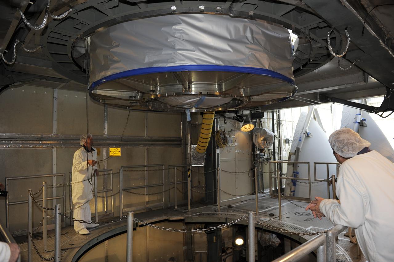 CAPE CANAVERAL, Fla. -- Technicians lower NASA's twin Gravity Recovery and Interior Laboratory (GRAIL) spacecraft into place atop a United Launch Alliance Delta II rocket on Space Launch Complex 17B at Cape Canaveral Air Force Station in Florida. The lunar probes are attached to a spacecraft adapter ring in their side-by-side launch configuration and wrapped in plastic to prevent contamination outside the clean room. The spacecraft will fly in tandem orbits around the moon for several months to measure its gravity field. GRAIL's primary science objectives are to determine the structure of the lunar interior, from crust to core, and to advance understanding of the thermal evolution of the moon. Launch is scheduled for Sept. 8. For more information, visit www.nasa.gov/grail. Photo credit: NASA/Kim Shiflett