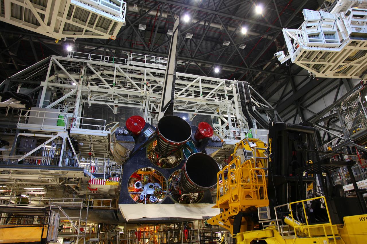 CAPE CANAVERAL, Fla. -- In Orbiter Processing Facility-2 at NASA’s Kennedy Space Center in Florida, a technician moves a Hyster forklift toward Engine #3 on space shuttle Atlantis. The forklift will be used to remove the engine and transport it to the Engine Shop for possible future use. Each of the three space shuttle main engines is 14 feet long and weighs 7,800 pounds.   Removal of the space shuttle main engines is part of the Transition and Retirement work that is being performed in order to prepare Atlantis for eventual display at the Kennedy Space Center Visitor Complex in Florida. Photo credit: Frankie Martin