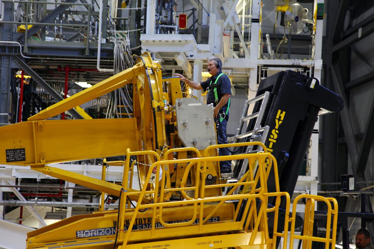 CAPE CANAVERAL, Fla. -- In Orbiter Processing Facility-2 at NASA’s Kennedy Space Center in Florida, a technician moves a Hyster forklift toward Engine #3 on space shuttle Atlantis. The forklift will be used to remove the engine and transport it to the Engine Shop for possible future use. Each of the three space shuttle main engines is 14 feet long and weighs 7,800 pounds.   Removal of the space shuttle main engines is part of the Transition and Retirement work that is being performed in order to prepare Atlantis for eventual display at the Kennedy Space Center Visitor Complex in Florida. Photo credit: Frankie Martin