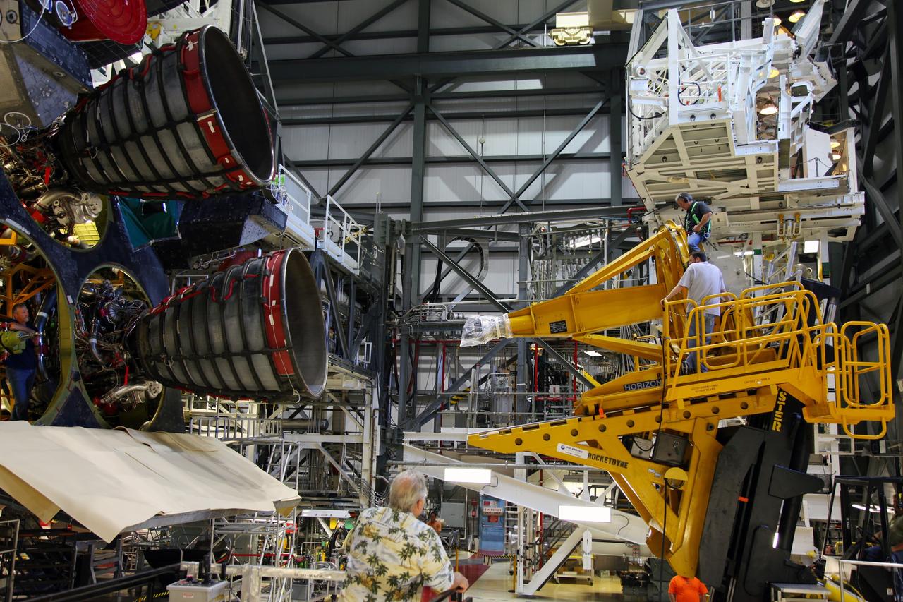 CAPE CANAVERAL, Fla. -- In Orbiter Processing Facility-2 at NASA’s Kennedy Space Center in Florida, a technician moves a Hyster forklift toward Engine #3 on space shuttle Atlantis. The forklift will be used to remove the engine and transport it to the Engine Shop for possible future use. Each of the three space shuttle main engines is 14 feet long and weighs 7,800 pounds. Removal of the space shuttle main engines is part of the Transition and Retirement work that is being performed in order to prepare Atlantis for eventual display at the Kennedy Space Center Visitor Complex in Florida. Photo credit: Frankie Martin