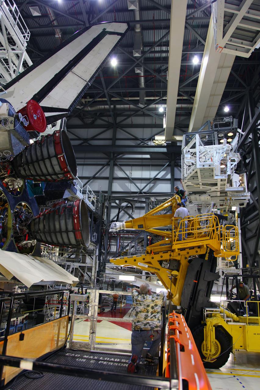 CAPE CANAVERAL, Fla. -- In Orbiter Processing Facility-2 at NASA’s Kennedy Space Center in Florida, a technician moves a Hyster forklift toward Engine #3 on space shuttle Atlantis. The forklift will be used to remove the engine and transport it to the Engine Shop for possible future use. Each of the three space shuttle main engines is 14 feet long and weighs 7,800 pounds. Removal of the space shuttle main engines is part of the Transition and Retirement work that is being performed in order to prepare Atlantis for eventual display at the Kennedy Space Center Visitor Complex in Florida. Photo credit: Frankie Martin