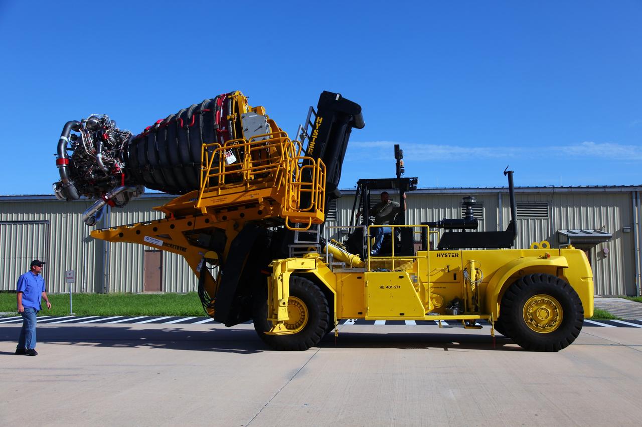 CAPE CANAVERAL, Fla. -- Technicians use a Hyster forklift to transport Engine #3 to the Engine Shop for possible future use after it was removed from space shuttle Atlantis in Orbiter Processing Facility-2 at NASA’s Kennedy Space Center in Florida. Each of the three space shuttle main engines is 14 feet long and weighs 7,800 pounds. Removal of the space shuttle main engines is part of the Transition and Retirement work that is being performed in order to prepare Atlantis for eventual display at the Kennedy Space Center Visitor Complex in Florida. Photo credit: Frankie Martin