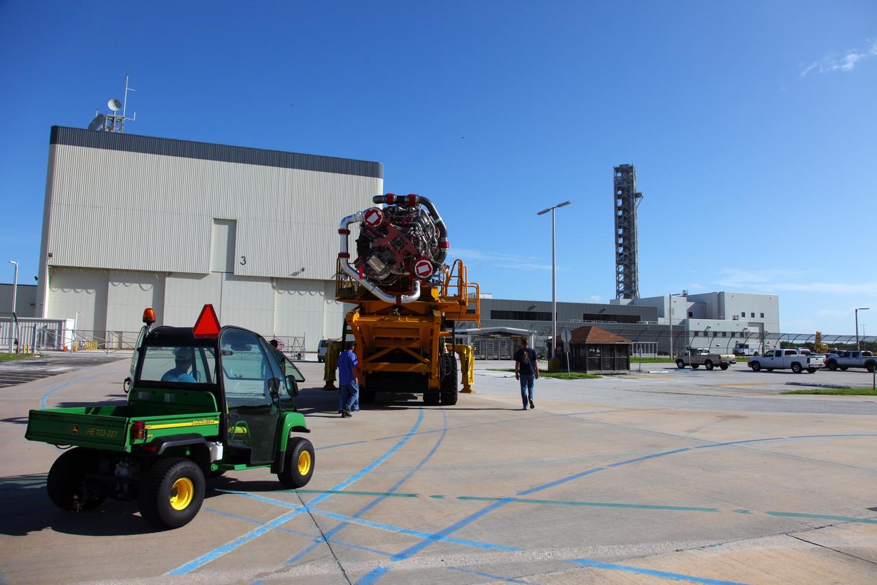 CAPE CANAVERAL, Fla. -- Technicians use a Hyster forklift to transport Engine #3 to the Engine Shop for possible future use after it was removed from space shuttle Atlantis in Orbiter Processing Facility-2 at NASA’s Kennedy Space Center in Florida. Each of the three space shuttle main engines is 14 feet long and weighs 7,800 pounds. Removal of the space shuttle main engines is part of the Transition and Retirement work that is being performed in order to prepare Atlantis for eventual display at the Kennedy Space Center Visitor Complex in Florida. Photo credit: Frankie Martin
