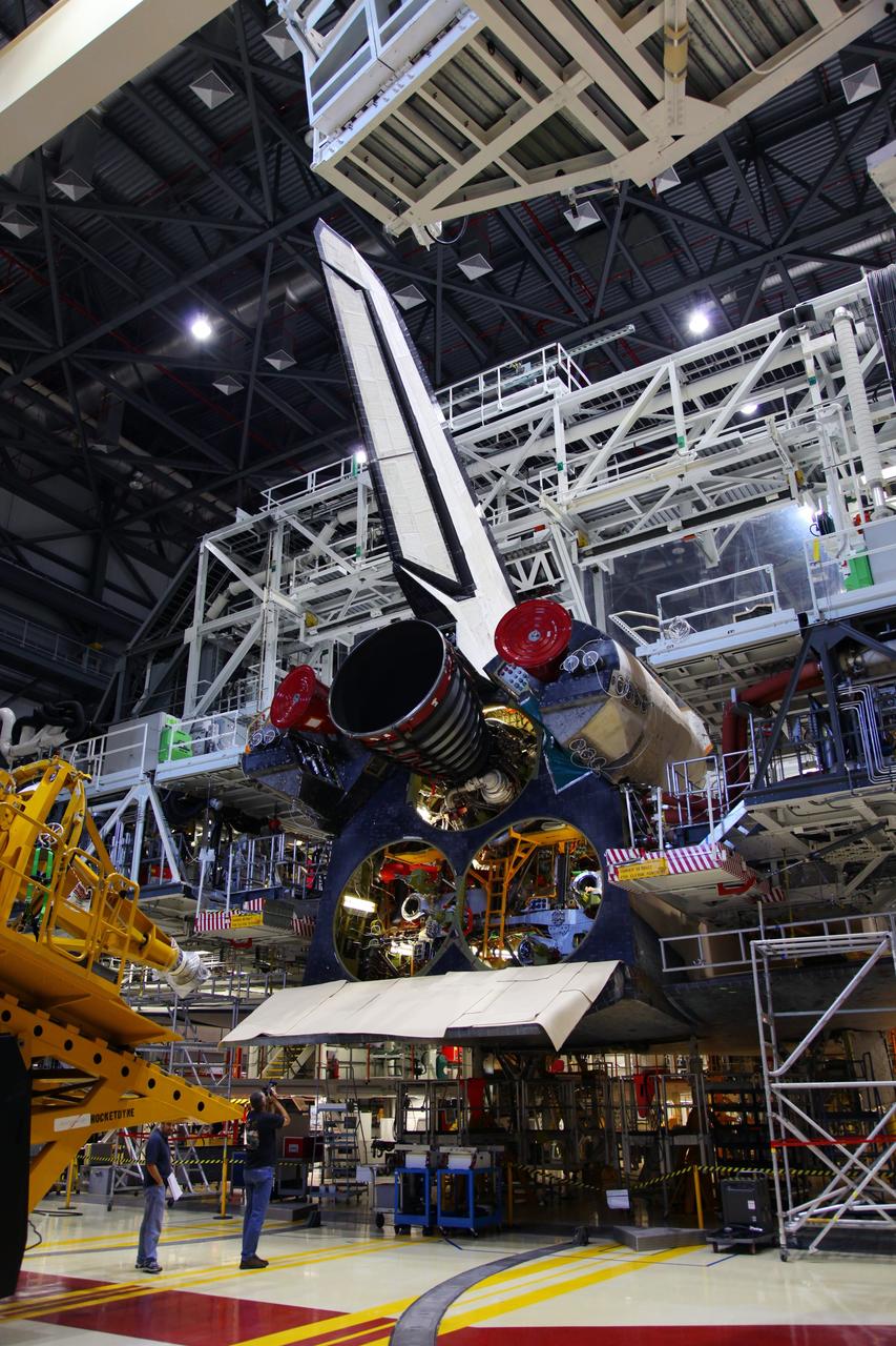 CAPE CANAVERAL, Fla. -- In Orbiter Processing Facility-2 at NASA’s Kennedy Space Center in Florida, technicians move a Hyster forklift toward Engine #1, the final engine to be removed from space shuttle Atlantis. The forklift will be used to remove the engine and transport it to the Engine Shop for possible future use. Each of the three space shuttle main engines is 14 feet long and weighs 7,800 pounds. Removal of the space shuttle main engines is part of the Transition and Retirement work that is being performed in order to prepare Atlantis for eventual display at the Kennedy Space Center Visitor Complex in Florida. Photo credit: Frankie Martin