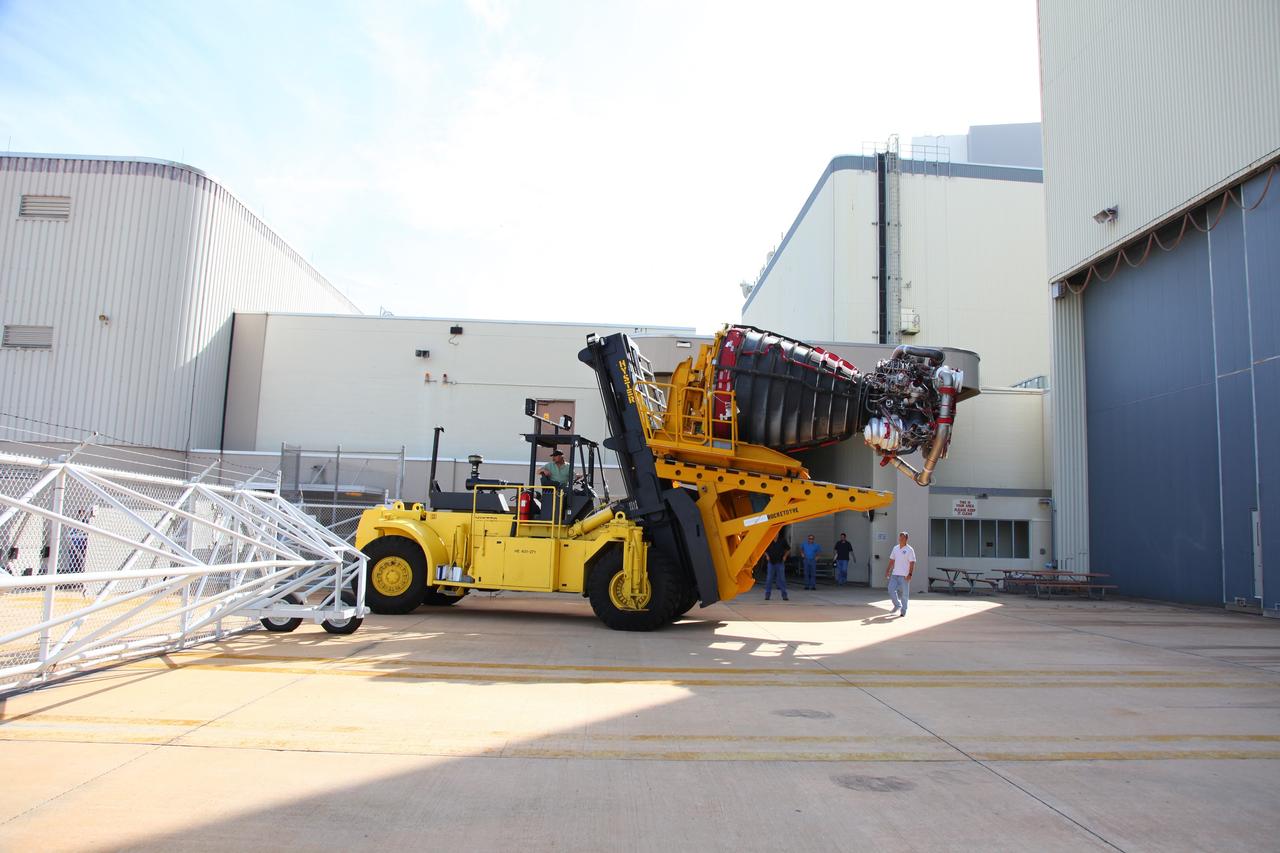 CAPE CANAVERAL, Fla. -- Technicians use a Hyster forklift to transport Engine #1, the final engine removed from space shuttle Atlantis, to the Engine Shop for possible future use. The engine was removed from Atlantis in Orbiter Processing Facility-2 at NASA’s Kennedy Space Center in Florida. Each of the three space shuttle main engines is 14 feet long and weighs 7,800 pounds. Removal of the space shuttle main engines is part of the Transition and Retirement work that is being performed in order to prepare Atlantis for eventual display at the Kennedy Space Center Visitor Complex in Florida. Photo credit: Frankie Martin