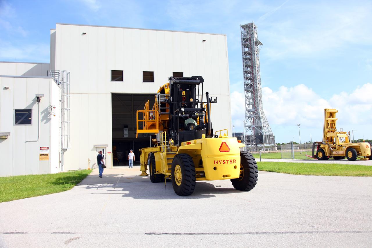 CAPE CANAVERAL, Fla. -- Technicians use a Hyster forklift to transport Engine #1, the final engine removed from space shuttle Atlantis, to the Engine Shop for possible future use. The engine was removed from Atlantis in Orbiter Processing Facility-2 at NASA’s Kennedy Space Center in Florida. Each of the three space shuttle main engines is 14 feet long and weighs 7,800 pounds. Removal of the space shuttle main engines is part of the Transition and Retirement work that is being performed in order to prepare Atlantis for eventual display at the Kennedy Space Center Visitor Complex in Florida. Photo credit: Frankie Martin