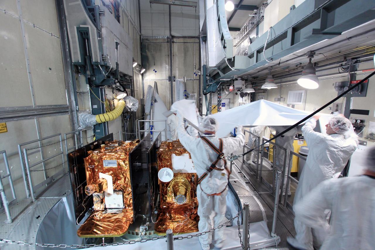 CAPE CANAVERAL, Fla. -- At Space Launch Complex 17B on Cape Canaveral Air Force Station in Florida, spacecraft technicians dressed in clean room attire, known as "bunny" suits, uncover NASA's twin Gravity Recovery and Interior Laboratory spacecraft during preparations to enclose it in the Delta payload fairing.    The fairing will protect the spacecraft from the impact of aerodynamic pressure and heating during ascent and will be jettisoned once the spacecraft is outside the Earth's atmosphere. Launch aboard a United Launch Alliance Delta II rocket from Pad 17B is scheduled for Sept. 8.  The spacecraft will fly in tandem orbits around the moon for several months to measure its gravity field. GRAIL's primary science objectives are to determine the structure of the lunar interior, from crust to core, and to advance understanding of the thermal evolution of the moon.  For more information, visit http://www.nasa.gov/grail. Photo credit: NASA/Jim Grossmann