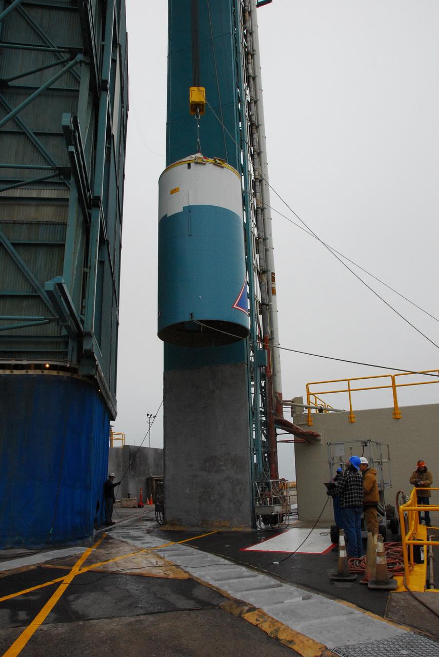 VANDENBERG AIR FORCE BASE, Calif. -- At Vandenberg Air Force Base in California, the interstage of the United Launch Alliance Delta II that will carry NASA's National Polar-orbiting Operational Environmental Satellite System Preparatory Project (NPP) satellite into space is lifted up the side of NASA's Space Launch Complex-2.    The interstage provides an interface between the launch vehicle's first and second stages. NPP represents a critical first step in building the next-generation of Earth-observing satellites. NPP will carry the first of the new sensors developed for this satellite fleet, now known as the Joint Polar Satellite System (JPSS) to be launched in 2016. NPP is the bridge between NASA's Earth Observing System (EOS) satellites and the forthcoming series of JPSS satellites. The mission will test key technologies and instruments for the JPSS missions. For more information, visit http://www.nasa.gov/NPP. Photo credit: NASA/VAFB, Rudy Bledsoe