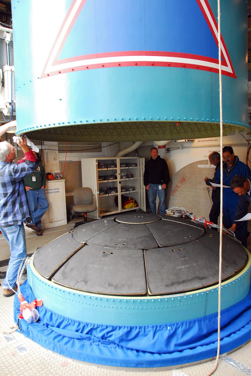 VANDENBERG AIR FORCE BASE, Calif. -- At NASA's Space Launch Complex-2 on Vandenberg Air Force Base in California, the interstage of the United Launch Alliance Delta II that will carry NASA's National Polar-orbiting Operational Environmental Satellite System Preparatory Project (NPP) satellite into space is lowered toward the rocket's first stage.    The interstage provides an interface between the launch vehicle's first and second stages. NPP represents a critical first step in building the next-generation of Earth-observing satellites. NPP will carry the first of the new sensors developed for this satellite fleet, now known as the Joint Polar Satellite System (JPSS) to be launched in 2016. NPP is the bridge between NASA's Earth Observing System (EOS) satellites and the forthcoming series of JPSS satellites. The mission will test key technologies and instruments for the JPSS missions. For more information, visit http://www.nasa.gov/NPP. Photo credit: NASA/VAFB, Rudy Bledsoe