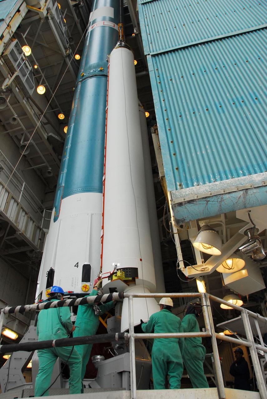 VANDENBERG AIR FORCE BASE, Calif. -- At Vandenberg Air Force Base in California, technicians monitor the progress as a solid rocket motor is attached to a United Launch Alliance Delta II rocket at NASA’s Space Launch Complex-2. The Delta II will carry NASA's National Polar-orbiting Operational Environmental Satellite System Preparatory Project (NPP) satellite. NPP represents a critical first step in building the next-generation of Earth-observing satellites. NPP will carry the first of the new sensors developed for this satellite fleet, now known as the Joint Polar Satellite System (JPSS) to be launched in 2016. NPP is the bridge between NASA's Earth Observing System (EOS) satellites and the forthcoming series of JPSS satellites. The mission will test key technologies and instruments for the JPSS missions. NPP is targeted to launch Oct. 25. For more information, visit http://www.nasa.gov/NPP. Photo credit: NASA/VAFB, Dan Liberotti