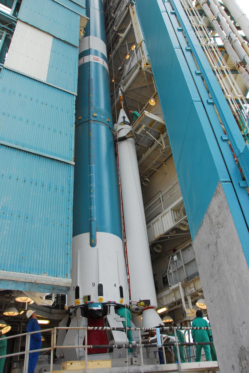 VANDENBERG AIR FORCE BASE, Calif. -- At Vandenberg Air Force Base in California, technicians monitor the progress as a crane lifts and positions a solid rocket motor for attachment to the United Launch Alliance Delta II that will carry NASA's National Polar-orbiting Operational Environmental Satellite System Preparatory Project (NPP) satellite at NASA's Space Launch Complex-2. NPP represents a critical first step in building the next-generation of Earth-observing satellites. NPP will carry the first of the new sensors developed for this satellite fleet, now known as the Joint Polar Satellite System (JPSS) to be launched in 2016. NPP is the bridge between NASA's Earth Observing System (EOS) satellites and the forthcoming series of JPSS satellites. The mission will test key technologies and instruments for the JPSS missions. NPP is targeted to launch Oct. 25. For more information, visit http://www.nasa.gov/NPP. Photo credit: NASA/VAFB, Dan Liberotti