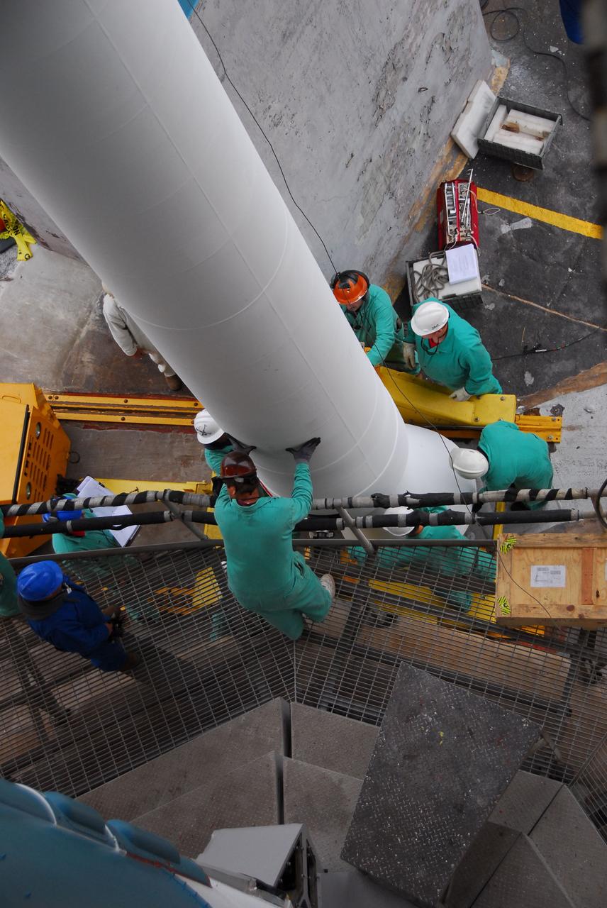 VANDENBERG AIR FORCE BASE, Calif. -- A view from above at NASA’s Space Launch Complex-2 at Vandenberg Air Force Base in California, as technicians help position a solid rocket motor for attachment to the United Launch Alliance Delta II that will carry NASA's National Polar-orbiting Operational Environmental Satellite System Preparatory Project (NPP) satellite into space. NPP represents a critical first step in building the next-generation of Earth-observing satellites. NPP will carry the first of the new sensors developed for this satellite fleet, now known as the Joint Polar Satellite System (JPSS) to be launched in 2016. NPP is the bridge between NASA's Earth Observing System (EOS) satellites and the forthcoming series of JPSS satellites. The mission will test key technologies and instruments for the JPSS missions. NPP is targeted to launch Oct. 25. For more information, visit http://www.nasa.gov/NPP. Photo credit: NASA/VAFB, Dan Liberotti