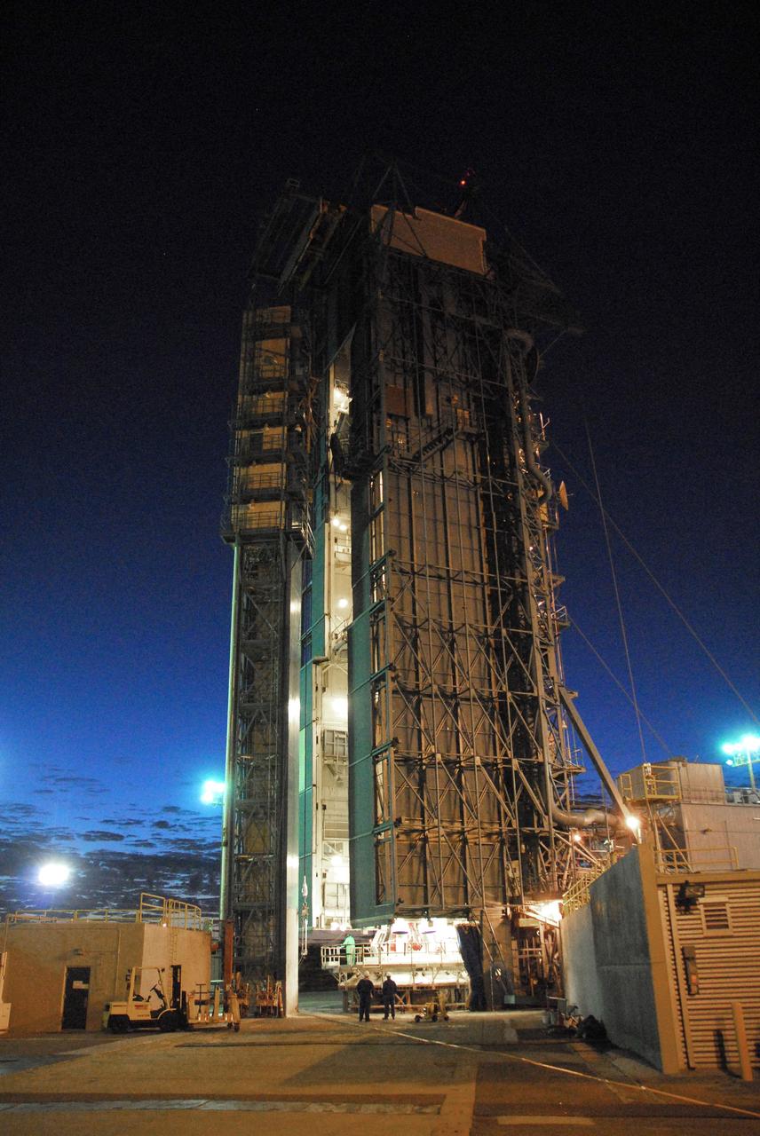 VANDENBERG AIR FORCE BASE, Calif. -- NASA’s Space Launch Complex-2 at Vandenberg Air Force Base in California, is illuminated against a midnight blue sky as solid rocket motors are attached to the United Launch Alliance Delta II rocket that will carry NASA's National Polar-orbiting Operational Environmental Satellite System Preparatory Project (NPP) satellite into space. NPP represents a critical first step in building the next-generation of Earth-observing satellites. NPP will carry the first of the new sensors developed for this satellite fleet, now known as the Joint Polar Satellite System (JPSS) to be launched in 2016. NPP is the bridge between NASA's Earth Observing System (EOS) satellites and the forthcoming series of JPSS satellites. The mission will test key technologies and instruments for the JPSS missions. NPP is targeted to launch Oct. 25. For more information, visit http://www.nasa.gov/NPP. Photo credit: NASA/VAFB, Mark Mackley