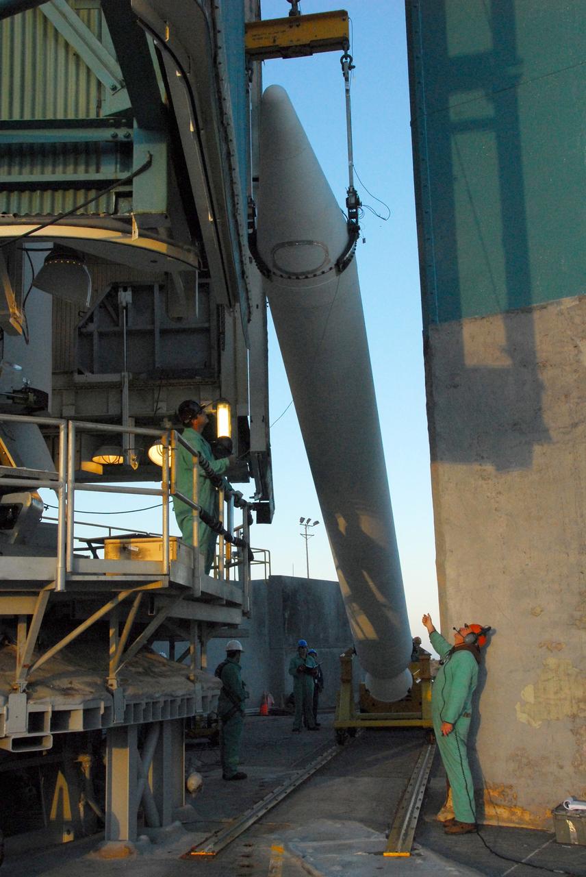 VANDENBERG AIR FORCE BASE, Calif. -- At NASA’s Space Launch Complex-2 at Vandenberg Air Force Base in California, technicians monitor the progress as a solid rocket motor is lifted for attachment to the United Launch Alliance Delta II rocket. The Delta II will carry NASA’s National Polar-orbiting Operational Environmental Satellite System Preparatory Project (NPP) satellite into space. NPP represents a critical first step in building the next-generation of Earth-observing satellites. NPP will carry the first of the new sensors developed for this satellite fleet, now known as the Joint Polar Satellite System (JPSS) to be launched in 2016. NPP is the bridge between NASA's Earth Observing System (EOS) satellites and the forthcoming series of JPSS satellites. The mission will test key technologies and instruments for the JPSS missions. NPP is targeted to launch Oct. 25. For more information, visit http://www.nasa.gov/NPP. Photo credit: NASA/VAFB, Mark Mackley