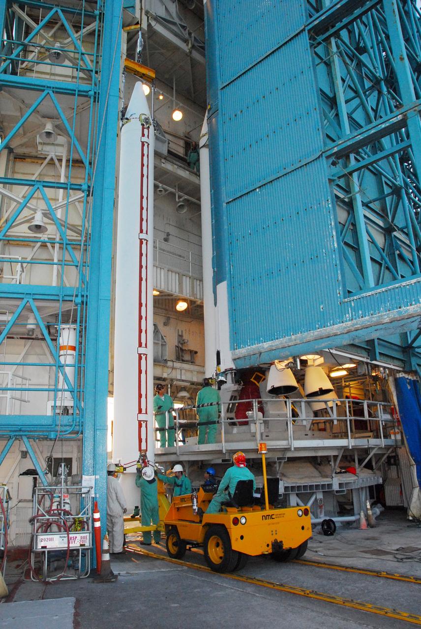 VANDENBERG AIR FORCE BASE, Calif. -- At NASA’s Space Launch Complex-2 at Vandenberg Air Force Base in California, several technicians assist as a crane begins to lift a solid rocket motor for attachment to the United Launch Alliance Delta II rocket. The Delta II will carry NASA’s National Polar-orbiting Operational Environmental Satellite System Preparatory Project (NPP) satellite into space. NPP represents a critical first step in building the next-generation of Earth-observing satellites. NPP will carry the first of the new sensors developed for this satellite fleet, now known as the Joint Polar Satellite System (JPSS) to be launched in 2016. NPP is the bridge between NASA's Earth Observing System (EOS) satellites and the forthcoming series of JPSS satellites. The mission will test key technologies and instruments for the JPSS missions. NPP is targeted to launch Oct. 25. For more information, visit http://www.nasa.gov/NPP. Photo credit: NASA/VAFB, Mark Mackley