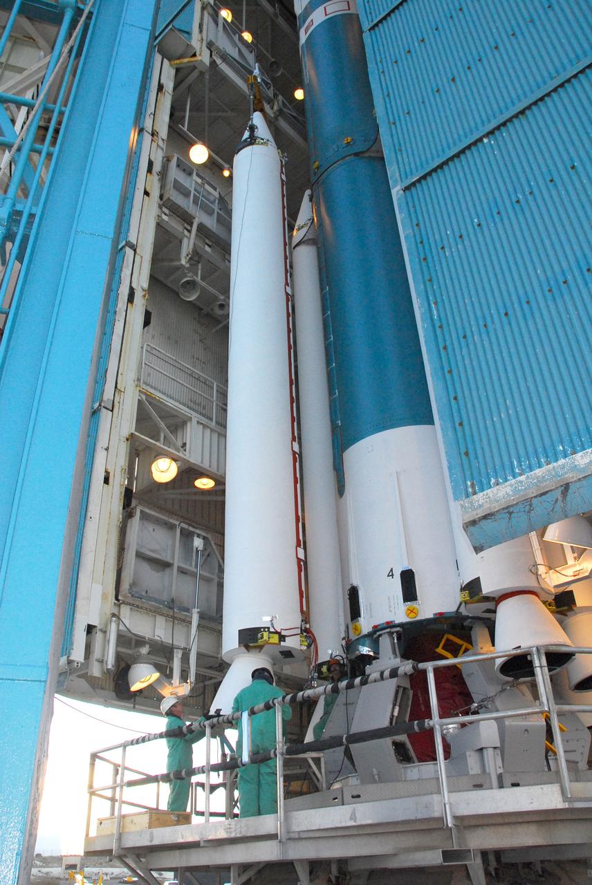 VANDENBERG AIR FORCE BASE, Calif. -- At NASA’s Space Launch Complex-2 at Vandenberg Air Force Base in California, technicians monitor the progress as a crane moves a solid rocket motor closer to the United Launch Alliance Delta II rocket. The Delta II will carry NASA’s National Polar-orbiting Operational Environmental Satellite System Preparatory Project (NPP) satellite into space. NPP represents a critical first step in building the next-generation of Earth-observing satellites. NPP will carry the first of the new sensors developed for this satellite fleet, now known as the Joint Polar Satellite System (JPSS) to be launched in 2016. NPP is the bridge between NASA's Earth Observing System (EOS) satellites and the forthcoming series of JPSS satellites. The mission will test key technologies and instruments for the JPSS missions. NPP is targeted to launch Oct. 25. For more information, visit http://www.nasa.gov/NPP. Photo credit: NASA/VAFB, Mark Mackley