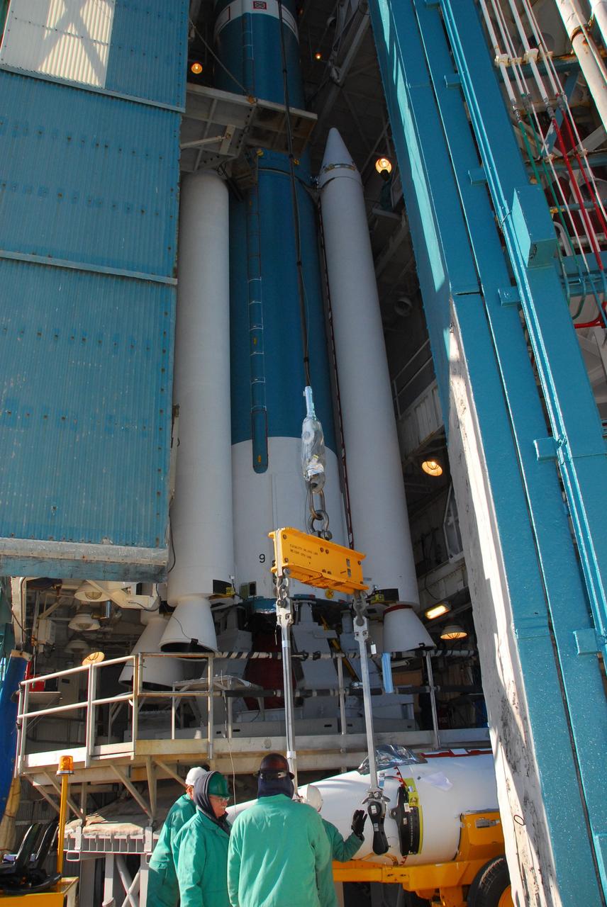 VANDENBERG AIR FORCE BASE, Calif. -- At NASA’s Space Launch Complex-2 at Vandenberg Air Force Base in California, technicians attach a crane to a solid rocket motor that will be lifted and attached to the United Launch Alliance Delta II rocket. The Delta II will carry NASA’s National Polar-orbiting Operational Environmental Satellite System Preparatory Project (NPP) satellite into space. NPP represents a critical first step in building the next-generation of Earth-observing satellites. NPP will carry the first of the new sensors developed for this satellite fleet, now known as the Joint Polar Satellite System (JPSS) to be launched in 2016. NPP is the bridge between NASA's Earth Observing System (EOS) satellites and the forthcoming series of JPSS satellites. The mission will test key technologies and instruments for the JPSS missions. NPP is targeted to launch Oct. 25. For more information, visit http://www.nasa.gov/NPP. Photo credit: NASA/VAFB, Mark Mackley