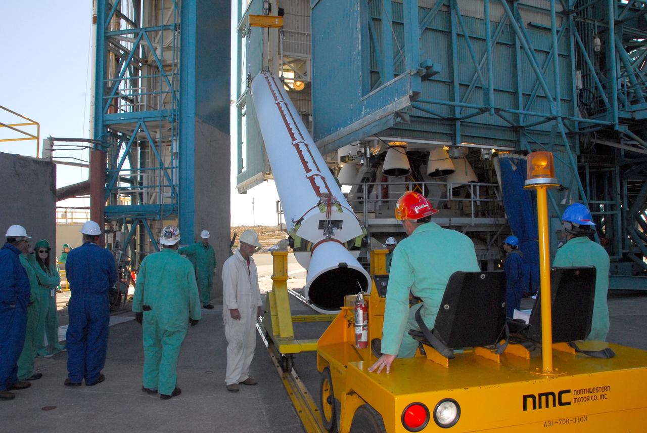 VANDENBERG AIR FORCE BASE, Calif. -- At NASA’s Space Launch Complex-2 at Vandenberg Air Force Base in California, technicians monitor the progress as a crane begins to lift up a solid rocket motor for the United Launch Alliance Delta II rocket. The Delta II will carry NASA’s National Polar-orbiting Operational Environmental Satellite System Preparatory Project (NPP) satellite into space. NPP represents a critical first step in building the next-generation of Earth-observing satellites. NPP will carry the first of the new sensors developed for this satellite fleet, now known as the Joint Polar Satellite System (JPSS) to be launched in 2016. NPP is the bridge between NASA's Earth Observing System (EOS) satellites and the forthcoming series of JPSS satellites. The mission will test key technologies and instruments for the JPSS missions. NPP is targeted to launch Oct. 25. For more information, visit http://www.nasa.gov/NPP. Photo credit: NASA/VAFB, Mark Mackley