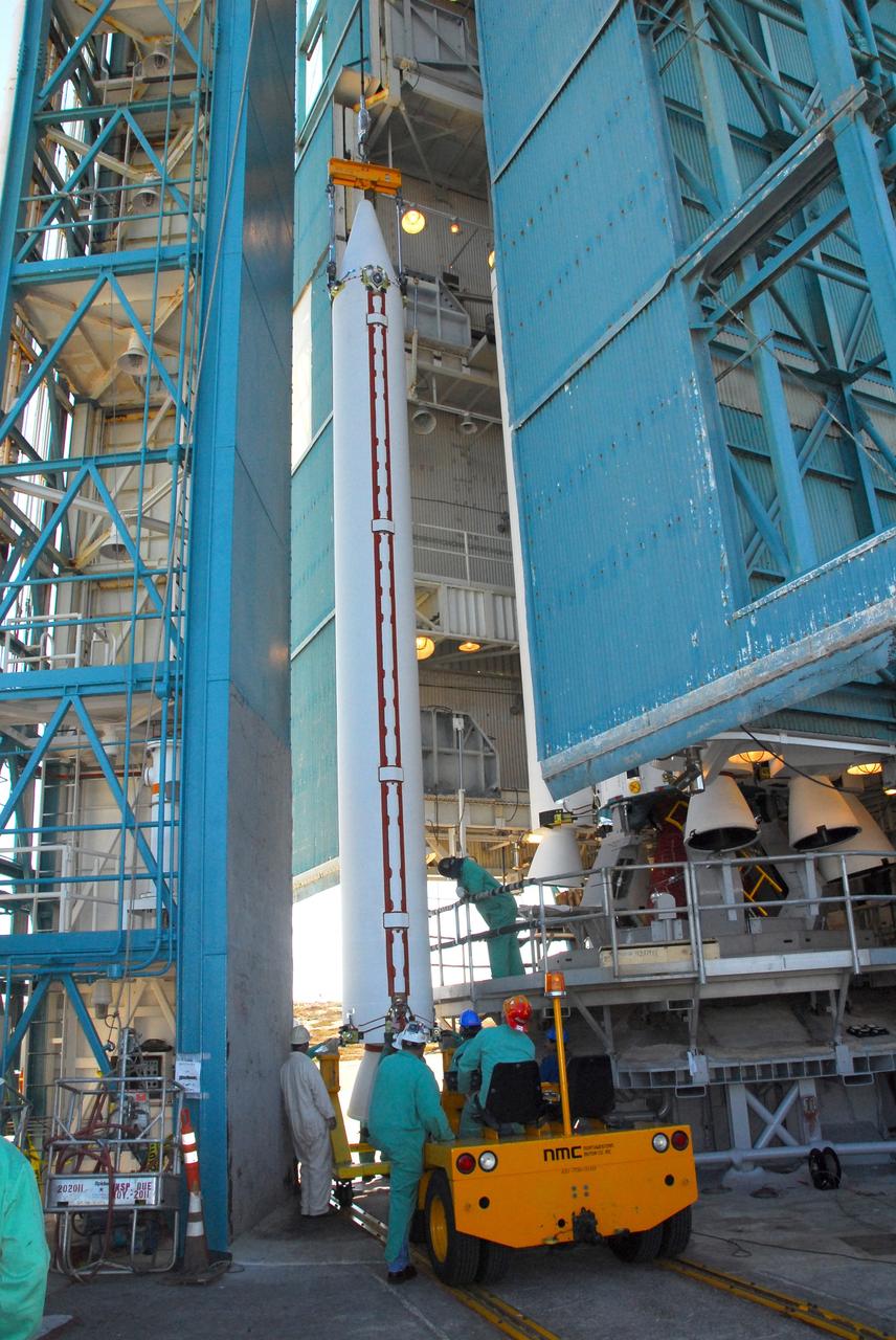 VANDENBERG AIR FORCE BASE, Calif. -- At NASA’s Space Launch Complex-2 at Vandenberg Air Force Base in California, technicians monitor the progress as a crane lifts a solid rocket motor for the United Launch Alliance Delta II rocket. The Delta II will carry NASA’s National Polar-orbiting Operational Environmental Satellite System Preparatory Project (NPP) satellite into space. NPP represents a critical first step in building the next-generation of Earth-observing satellites. NPP will carry the first of the new sensors developed for this satellite fleet, now known as the Joint Polar Satellite System (JPSS) to be launched in 2016. NPP is the bridge between NASA's Earth Observing System (EOS) satellites and the forthcoming series of JPSS satellites. The mission will test key technologies and instruments for the JPSS missions. NPP is targeted to launch Oct. 25. For more information, visit http://www.nasa.gov/NPP. Photo credit: NASA/VAFB, Mark Mackley