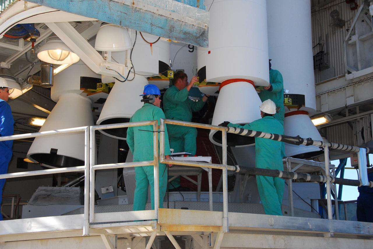 VANDENBERG AIR FORCE BASE, Calif. -- At NASA’s Space Launch Complex-2 at Vandenberg Air Force Base in California, technicians assist as a crane is used to position a solid rocket motor for attachment to the United Launch Alliance Delta II rocket. The Delta II will carry NASA’s National Polar-orbiting Operational Environmental Satellite System Preparatory Project (NPP) satellite into space. NPP represents a critical first step in building the next-generation of Earth-observing satellites. NPP will carry the first of the new sensors developed for this satellite fleet, now known as the Joint Polar Satellite System (JPSS) to be launched in 2016. NPP is the bridge between NASA's Earth Observing System (EOS) satellites and the forthcoming series of JPSS satellites. The mission will test key technologies and instruments for the JPSS missions. NPP is targeted to launch Oct. 25. For more information, visit http://www.nasa.gov/NPP. Photo credit: NASA/VAFB, Mark Mackley
