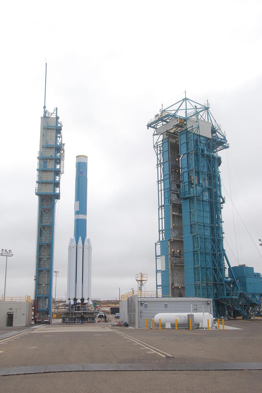 VANDENBERG AIR FORCE BASE, Calif. -- At Vandenberg Air Force Base in California, the first stage of a United Launch Alliance Delta II rocket with several solid rocket motors attached sits on NASA’s Space Launch Complex-2, while the service tower to the right awaits delivery of the Delta II second stage. The Delta II will carry NASA's National Polar-orbiting Operational Environmental Satellite System Preparatory Project (NPP) satellite into space.    NPP represents a critical first step in building the next-generation of Earth-observing satellites. NPP will carry the first of the new sensors developed for this satellite fleet, now known as the Joint Polar Satellite System (JPSS) to be launched in 2016. NPP is the bridge between NASA's Earth Observing System (EOS) satellites and the forthcoming series of JPSS satellites. The mission will test key technologies and instruments for the JPSS missions. NPP is targeted to launch Oct. 25. For more information, visit http://www.nasa.gov/NPP. Photo credit: NASA/VAFB