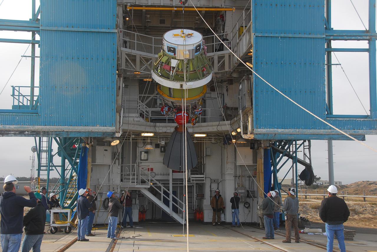 VANDENBERG AIR FORCE BASE, Calif. -- At Vandenberg Air Force Base in California, technicians monitor the progress as the AJ10 engine for the second stage of a United Launch Alliance Delta II rocket is hoisted up in the service tower at NASA’s Space Launch Complex-2. The Delta II will carry NASA's National Polar-orbiting Operational Environmental Satellite System Preparatory Project (NPP) satellite into space.    NPP represents a critical first step in building the next-generation of Earth-observing satellites. NPP will carry the first of the new sensors developed for this satellite fleet, now known as the Joint Polar Satellite System (JPSS) to be launched in 2016. NPP is the bridge between NASA's Earth Observing System (EOS) satellites and the forthcoming series of JPSS satellites. The mission will test key technologies and instruments for the JPSS missions. NPP is targeted to launch Oct. 25. For more information, visit http://www.nasa.gov/NPP. Photo credit: NASA/VAFB