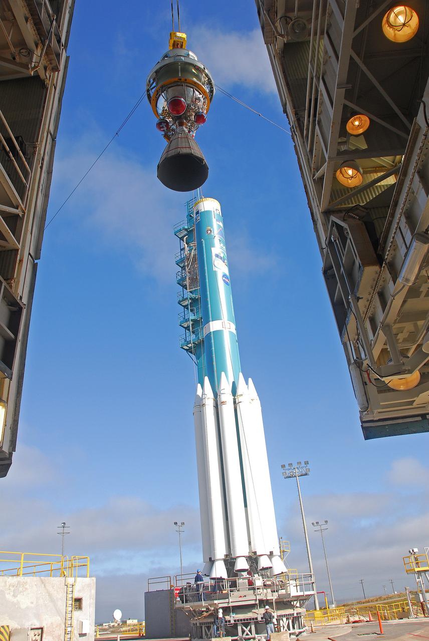 VANDENBERG AIR FORCE BASE, Calif. – This view is from inside the service tower at NASA’s Space Launch Complex-2 at Vandenberg Air Force Base in California, as the second stage of the United Launch Alliance Delta II rocket is hoisted up. The third stage of the rocket with several solid rocket motors attached sits on the launch pad. The Delta II will carry NASA's National Polar-orbiting Operational Environmental Satellite System Preparatory Project (NPP) satellite into space.    NPP represents a critical first step in building the next-generation of Earth-observing satellites. NPP will carry the first of the new sensors developed for this satellite fleet, now known as the Joint Polar Satellite System (JPSS) to be launched in 2016. NPP is the bridge between NASA's Earth Observing System (EOS) satellites and the forthcoming series of JPSS satellites. The mission will test key technologies and instruments for the JPSS missions. NPP is targeted to launch Oct. 25. For more information, visit http://www.nasa.gov/NPP. Photo credit: NASA/VAFB