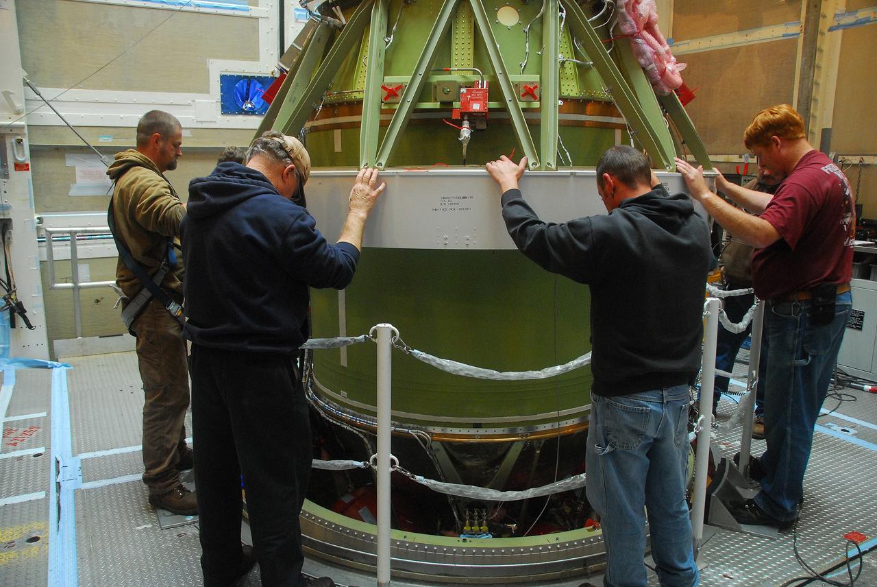 VANDENBERG AIR FORCE BASE, Calif. -- Technicians secure the AJ10 engine for the second stage of the United Launch Alliance Delta II rocket on a work stand at NASA’s Space Launch Complex-2 service tower. The Delta II will carry NASA's National Polar-orbiting Operational Environmental Satellite System Preparatory Project (NPP) satellite into space.    NPP represents a critical first step in building the next-generation of Earth-observing satellites. NPP will carry the first of the new sensors developed for this satellite fleet, now known as the Joint Polar Satellite System (JPSS) to be launched in 2016. NPP is the bridge between NASA's Earth Observing System (EOS) satellites and the forthcoming series of JPSS satellites. The mission will test key technologies and instruments for the JPSS missions. NPP is targeted to launch Oct. 25. For more information, visit http://www.nasa.gov/NPP. Photo credit: NASA/VAFB