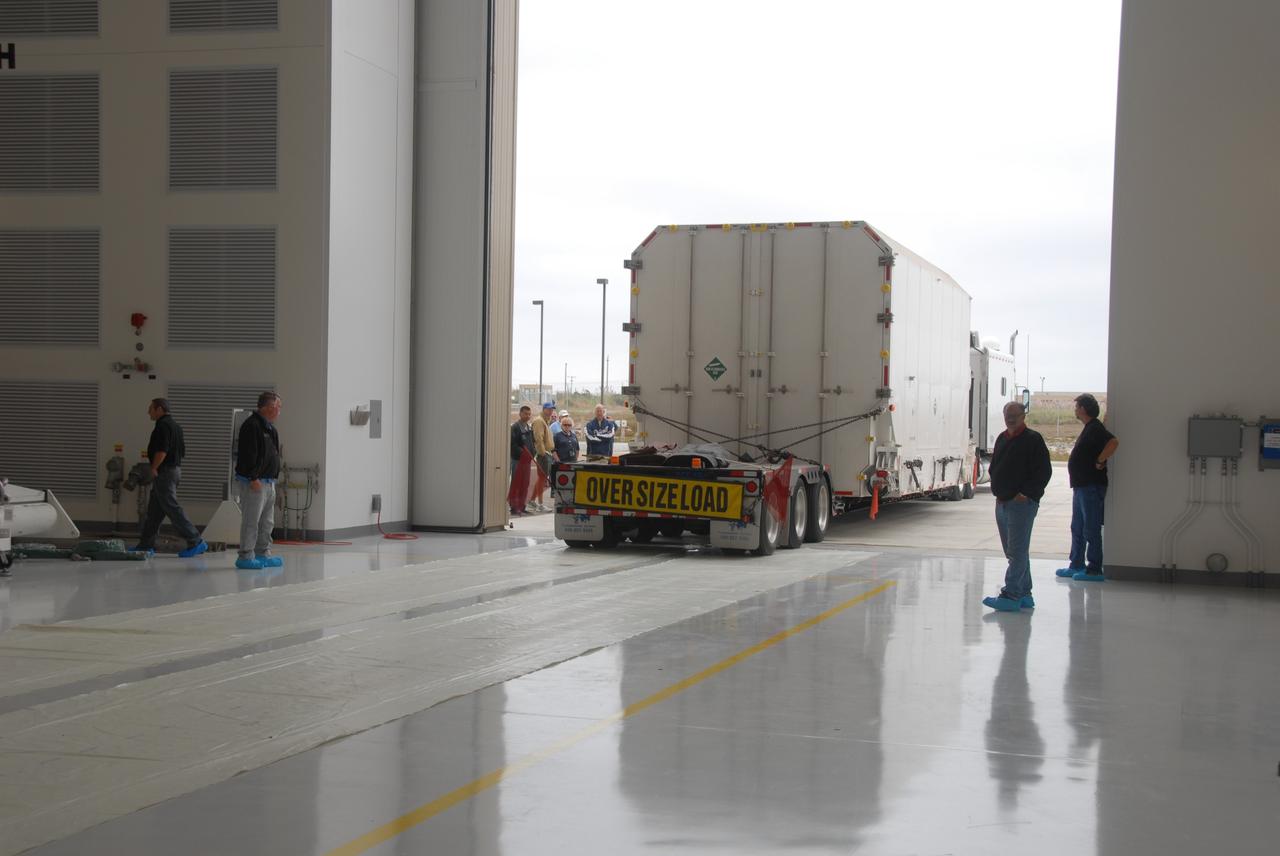 VANDENBERG AIR FORCE BASE, Calif. -- The environmentally controlled transportation container holding NASA's National Polar-orbiting Operational Environmental Satellite System Preparatory Project (NPP) satellite is delivered into the Astrotech payload processing facility on Vandenberg Air Force Base in California.    NPP represents a critical first step in building the next-generation of Earth-observing satellites. NPP will carry the first of the new sensors developed for this satellite fleet, now known as the Joint Polar Satellite System (JPSS), to be launched in 2016. NPP is the bridge between NASA's Earth Observing System (EOS) satellites and the forthcoming series of JPSS satellites. The mission will test key technologies and instruments for the JPSS missions. NPP is targeted to launch Oct. 25 from Space Launch Complex-2 aboard a United Launch Alliance Delta II rocket. For more information, visit http://www.nasa.gov/NPP.    Photo credit: USAF 30th Space Communications Squadron/Doug Gruben, VAFB