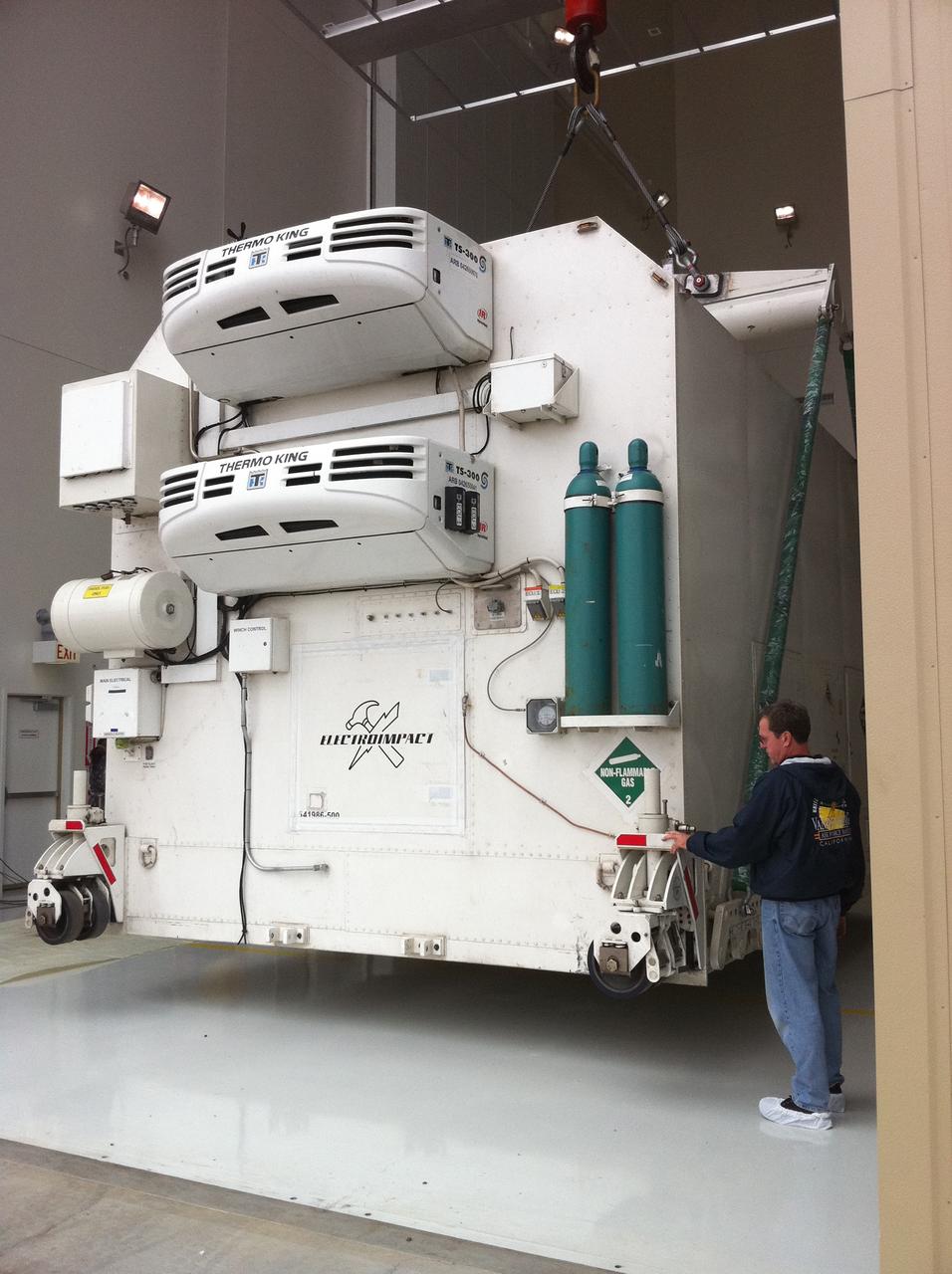 VANDENBERG AIR FORCE BASE, Calif. -- The environmentally controlled transportation container holding NASA's National Polar-orbiting Operational Environmental Satellite System Preparatory Project (NPP) satellite is lifted from its delivery truck at the Astrotech payload processing facility on Vandenberg Air Force Base in California.    NPP represents a critical first step in building the next-generation of Earth-observing satellites. NPP will carry the first of the new sensors developed for this satellite fleet, now known as the Joint Polar Satellite System (JPSS), to be launched in 2016. NPP is the bridge between NASA's Earth Observing System (EOS) satellites and the forthcoming series of JPSS satellites. The mission will test key technologies and instruments for the JPSS missions. NPP is targeted to launch Oct. 25 from Space Launch Complex-2 aboard a United Launch Alliance Delta II rocket. For more information, visit http://www.nasa.gov/NPP.    Photo credit: NASA/Jerry Nagy, VAFB